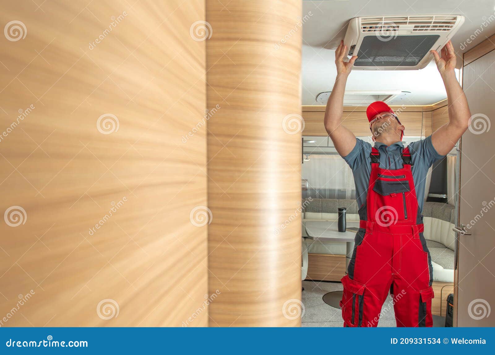 rv service worker replacing or fixing travel trailer air condition