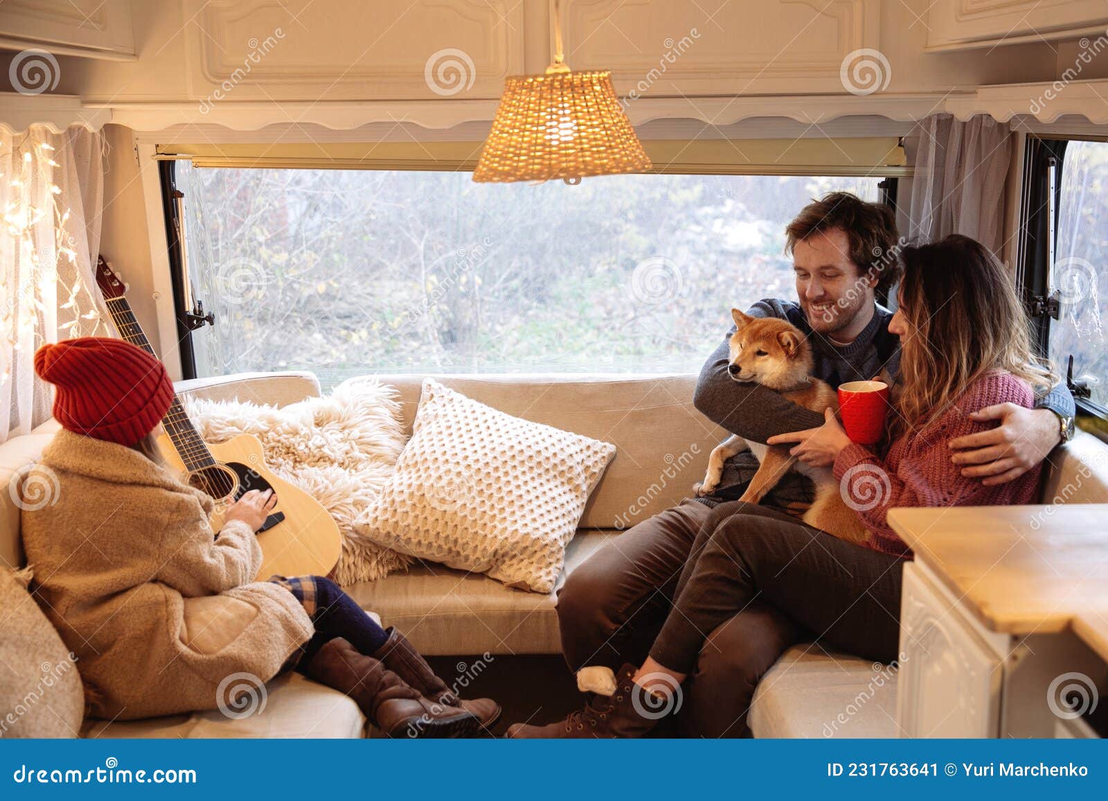 winter vacation in rv of parents and kid. happy mom and dad inside camper car travel with child