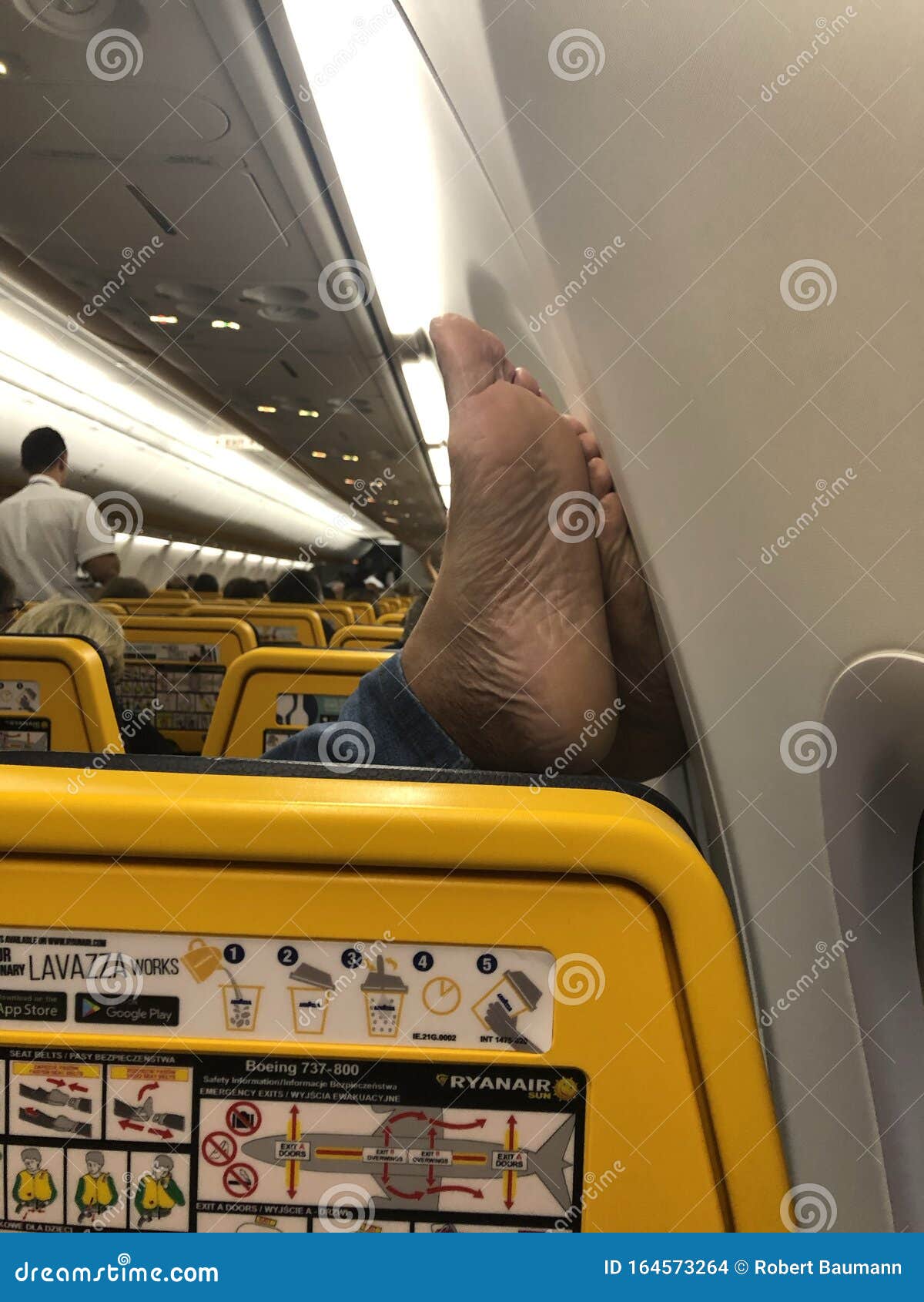 04/11/2019 - Ryanair Flight from Warsaw in Poland To Amman in - Passenger Resting His Feet the Wall Inside the Aeroplane Editorial Stock Image - Image of 164573264