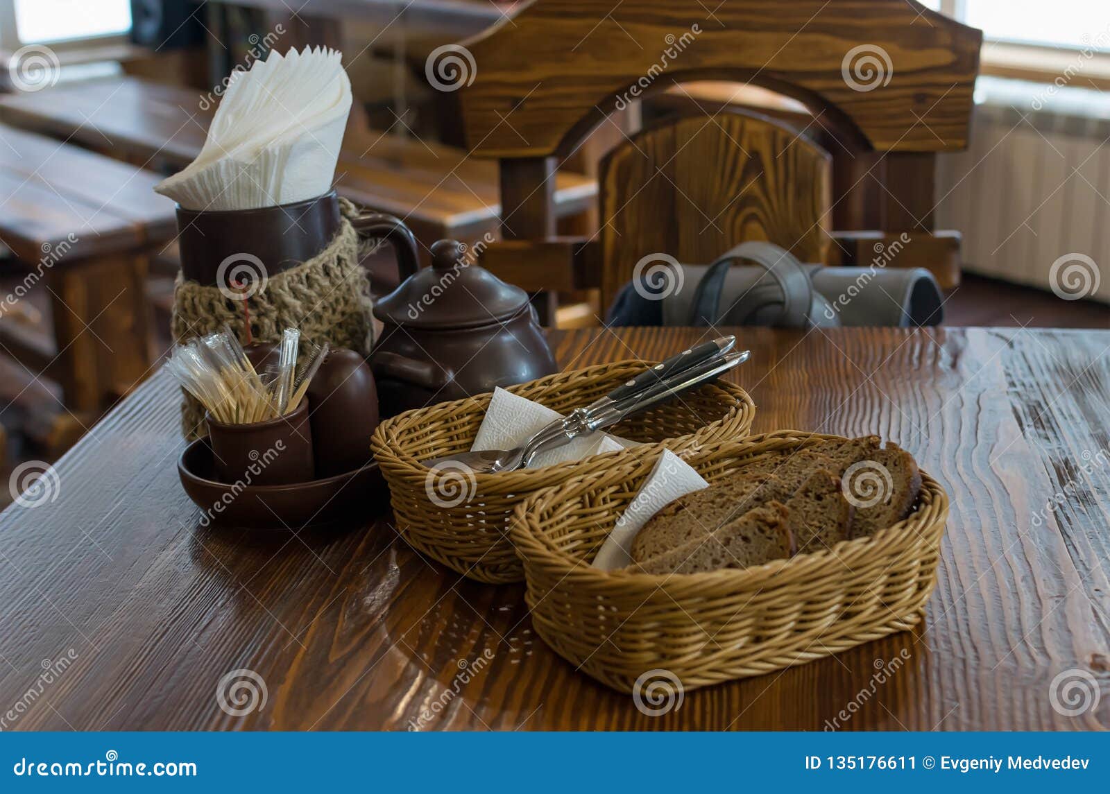 Rye Bread in Wicker Baskets on the Table and Cutlery in the Restaurant