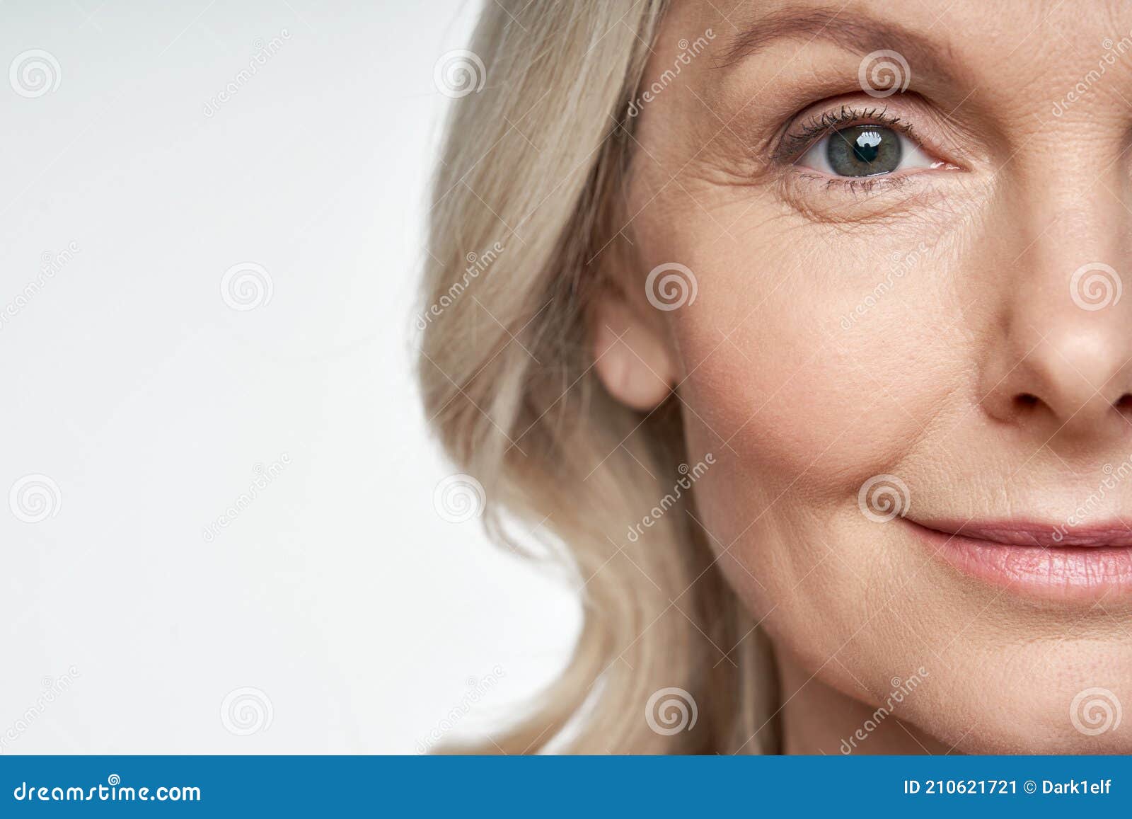 50s mid aged woman looking at camera. anti age skin care. half face crop