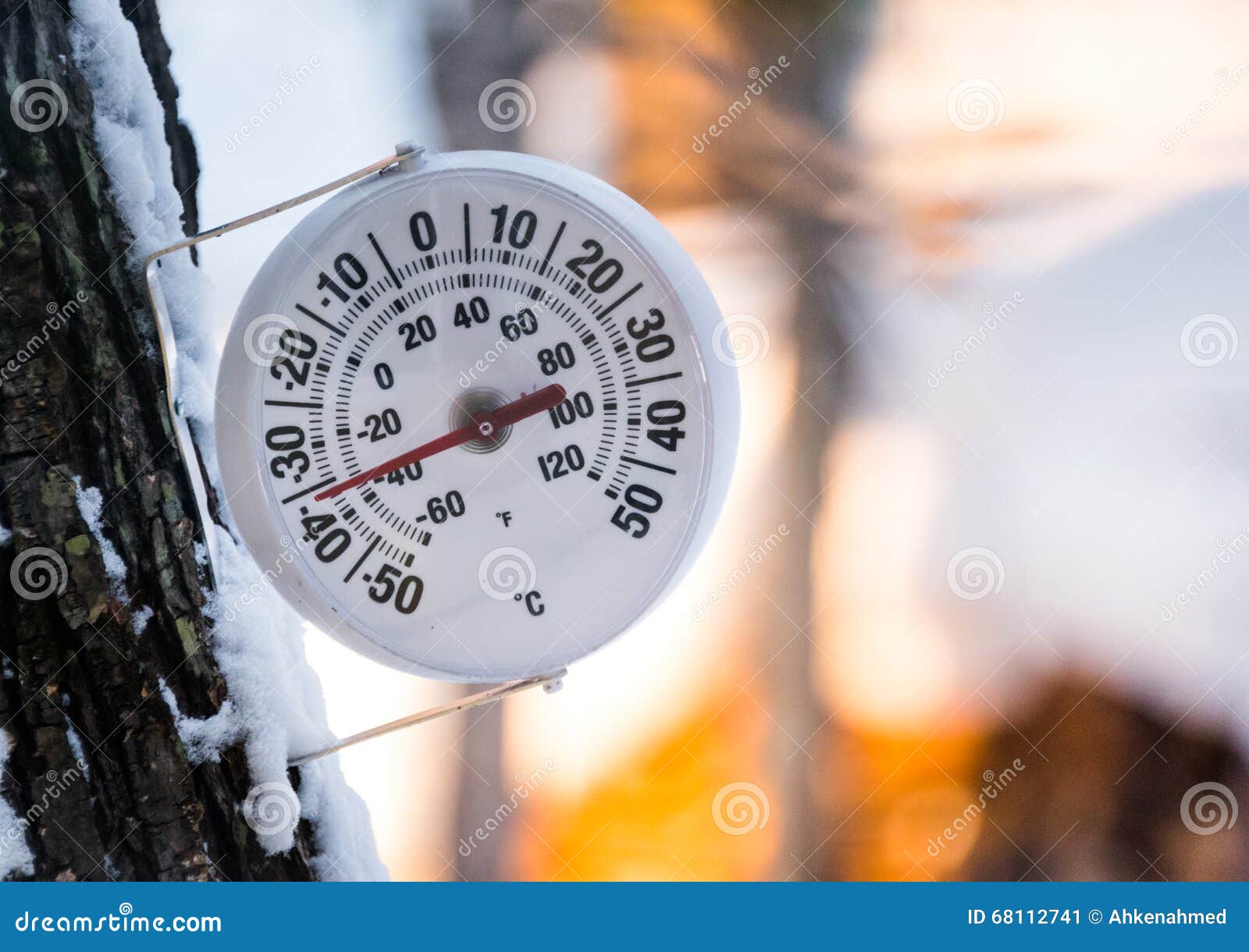 Large round analog thermometer hanging from bracket on outside wall Stock  Photo - Alamy