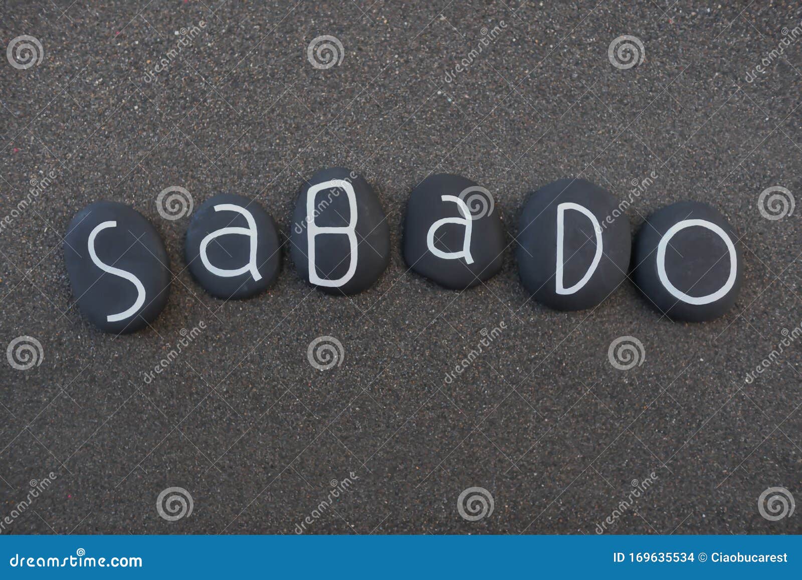 sabado, seventh day of the week in portuguese language composed with black colored stone letters over black volcanic sand