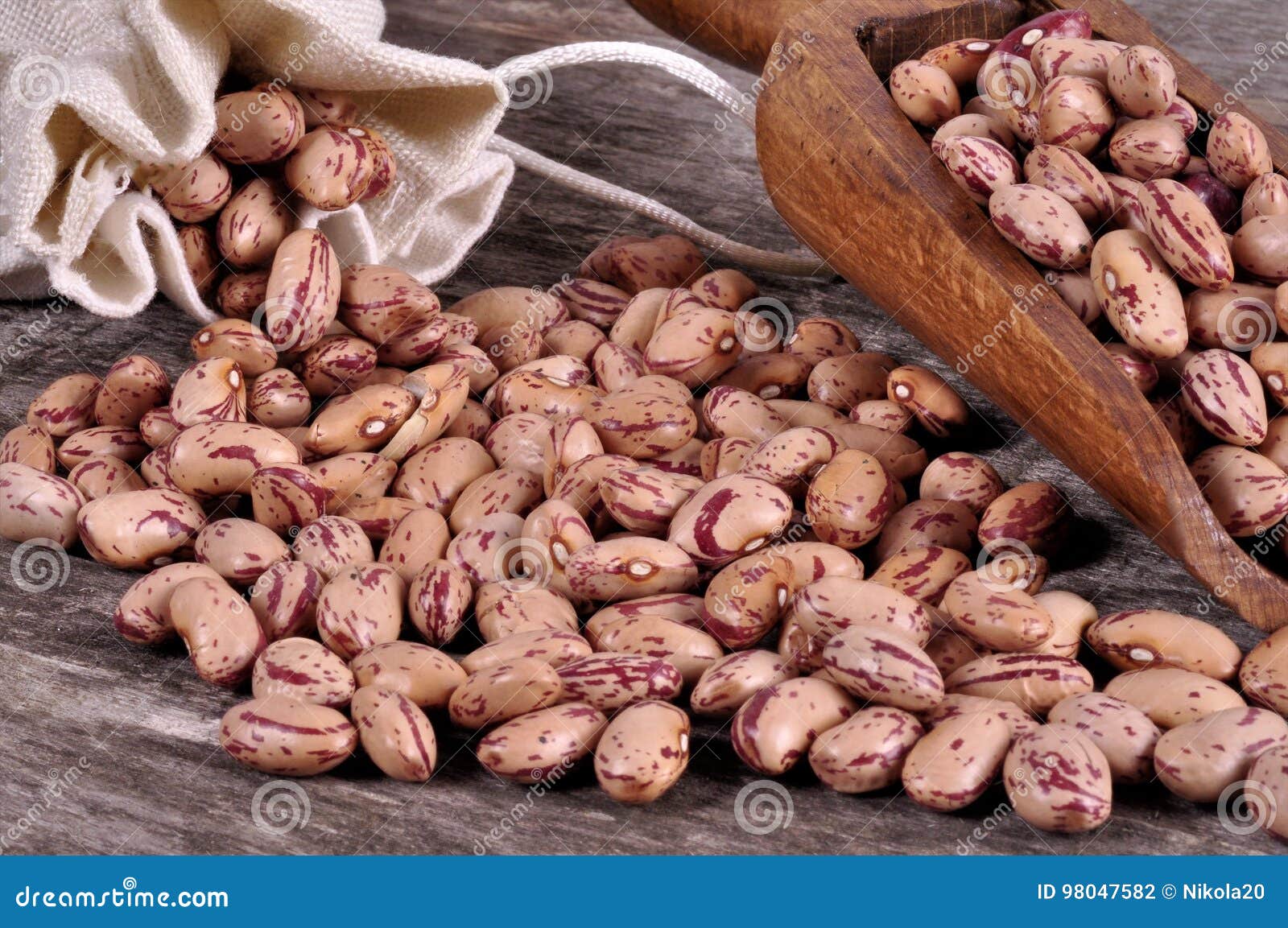 Sack of mix beans spill beans with beans on wooden table