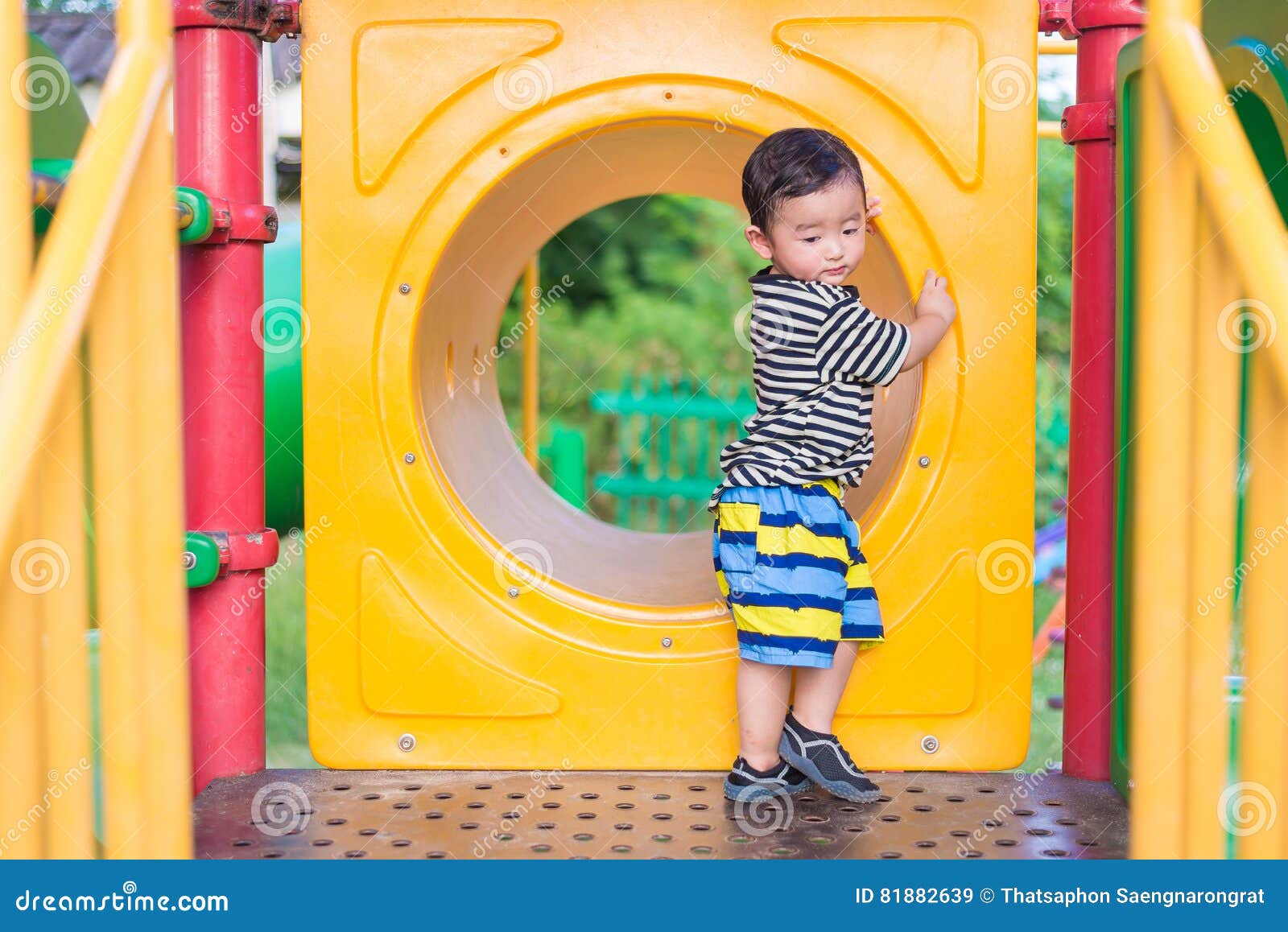 Sad Asian Boy Playing In Yellow Tunnel At The Playground With Sunlight In Summer Yellow Tube Shallow Dof Sad Asian Boy Playing In Yellow Tunnel At The Playground With Sunlight In Summer Yellow Tube Shallow Dof
