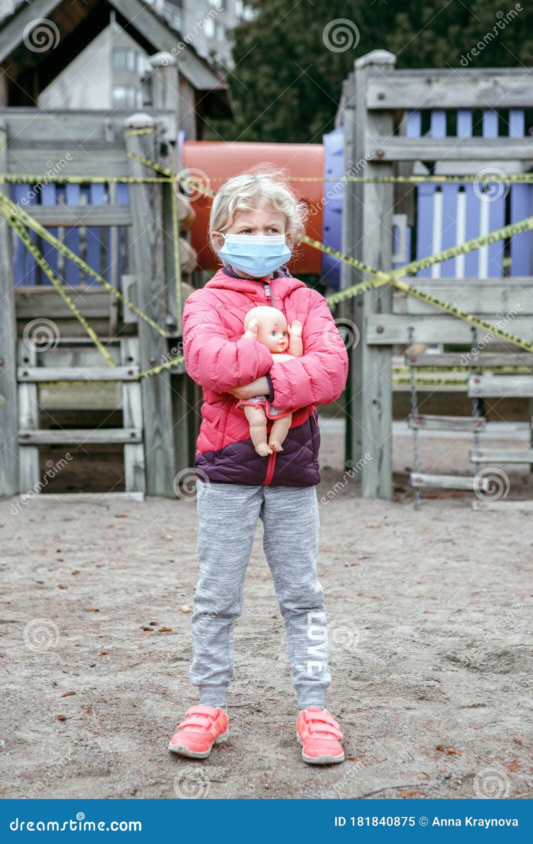 Download Sad Caucasian Girl In Face Mask With Baby Toy On Closed Playground Outdoor. Kids Play Area ...