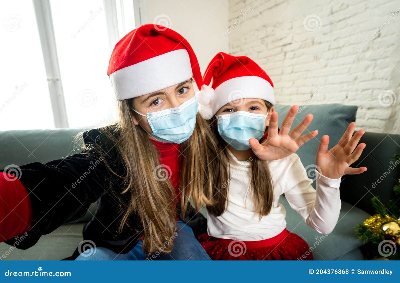 Santa Claus wears a face mask covering while waiting for children