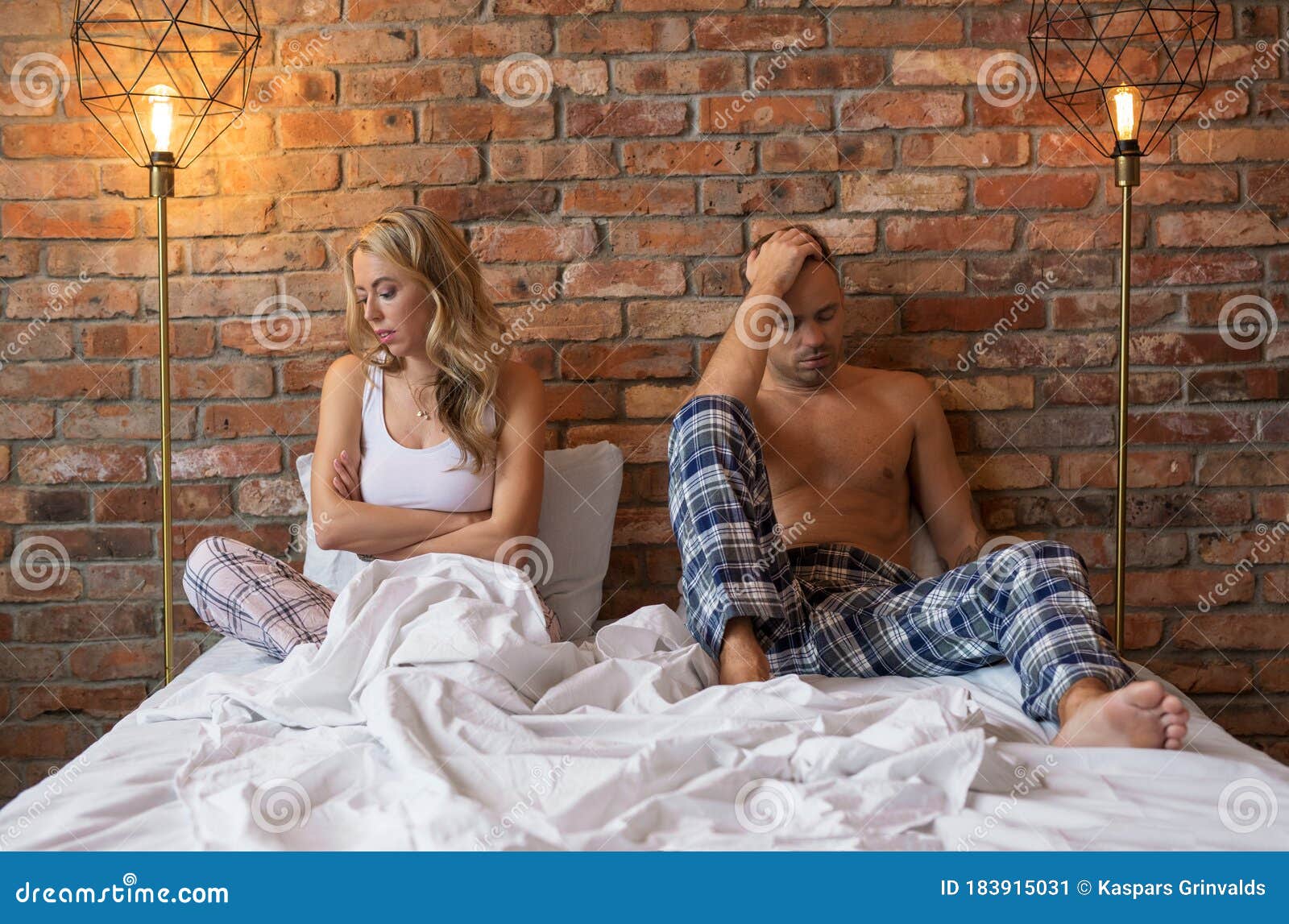 sad couple having problems in bedroom