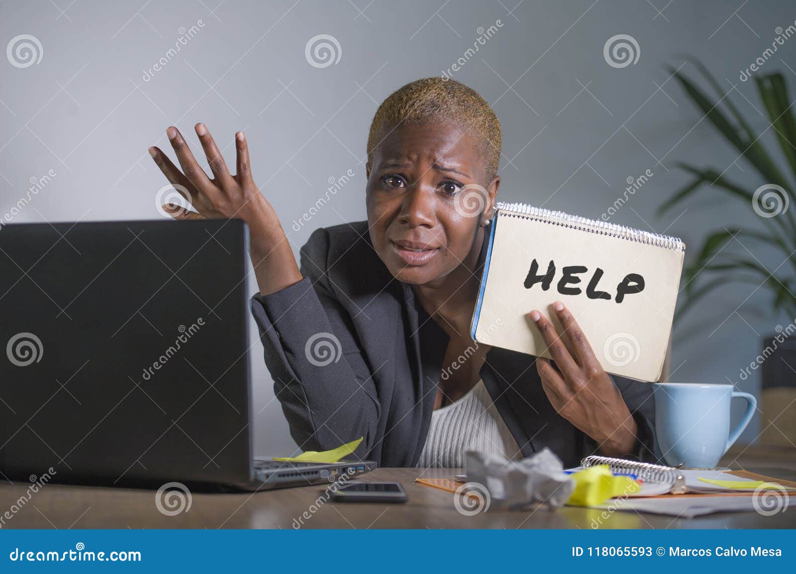 sad and depressed black afro american woman suffering stressed at office working with laptop computer feeling overwhelmed asking f