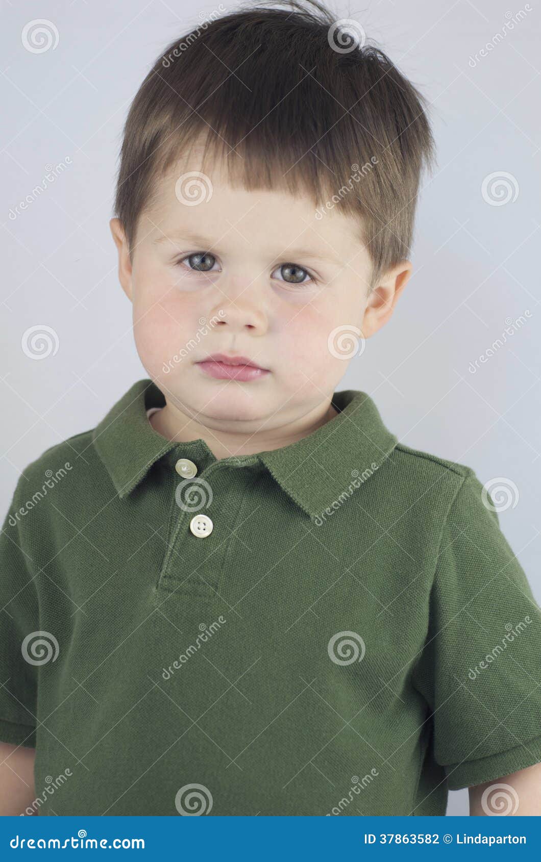 Sad Faced Little Boy stock photo. Image of small, green - 37863582