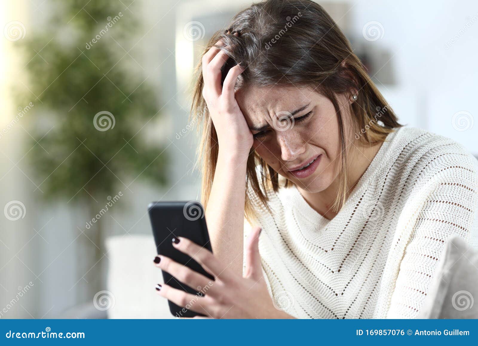 Sad Girl Complaining Holding Smart Phone at Home Stock Photo ...