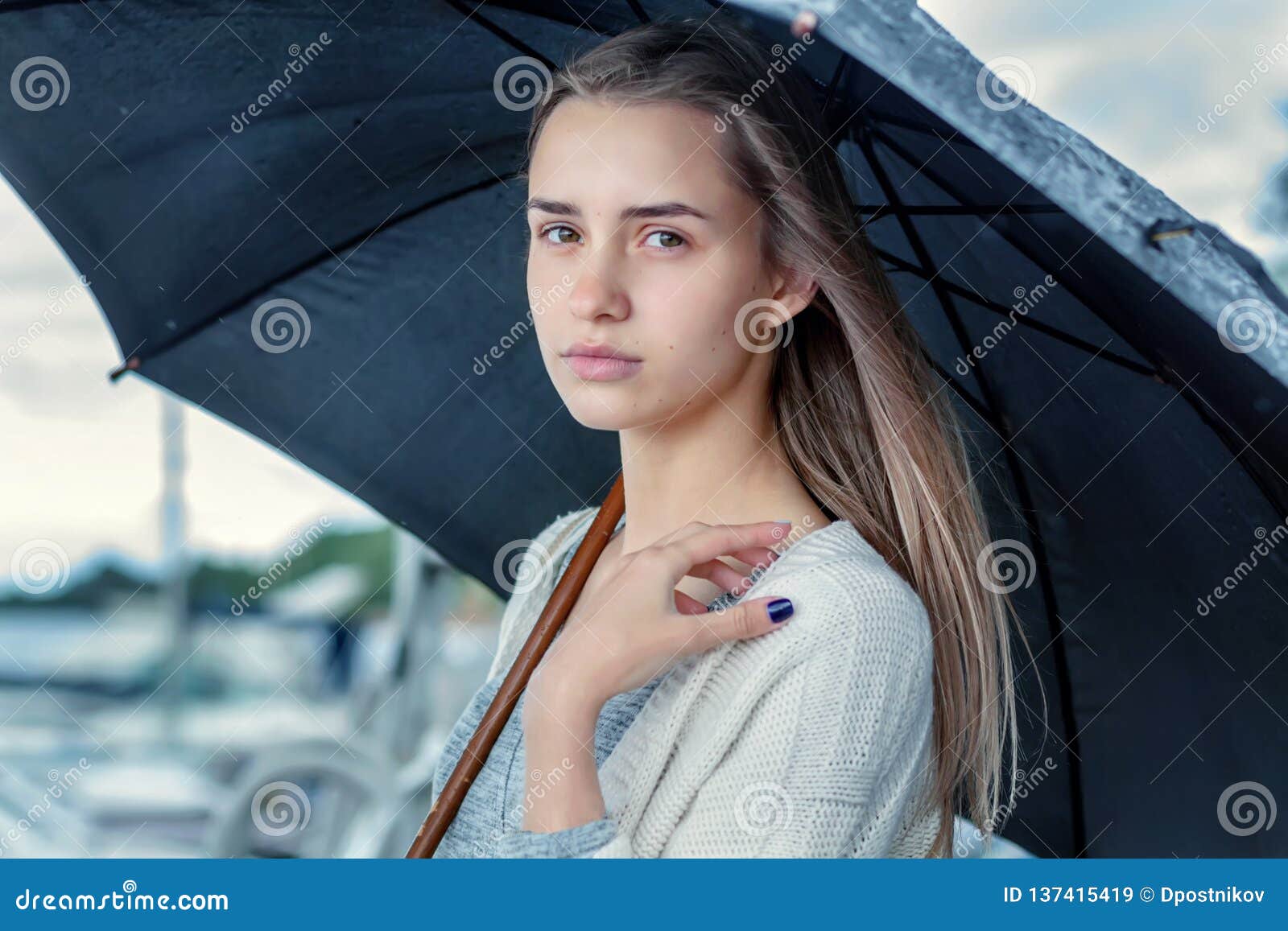 Sad Girl Hiding Under A Black Umbrella From The Rain
