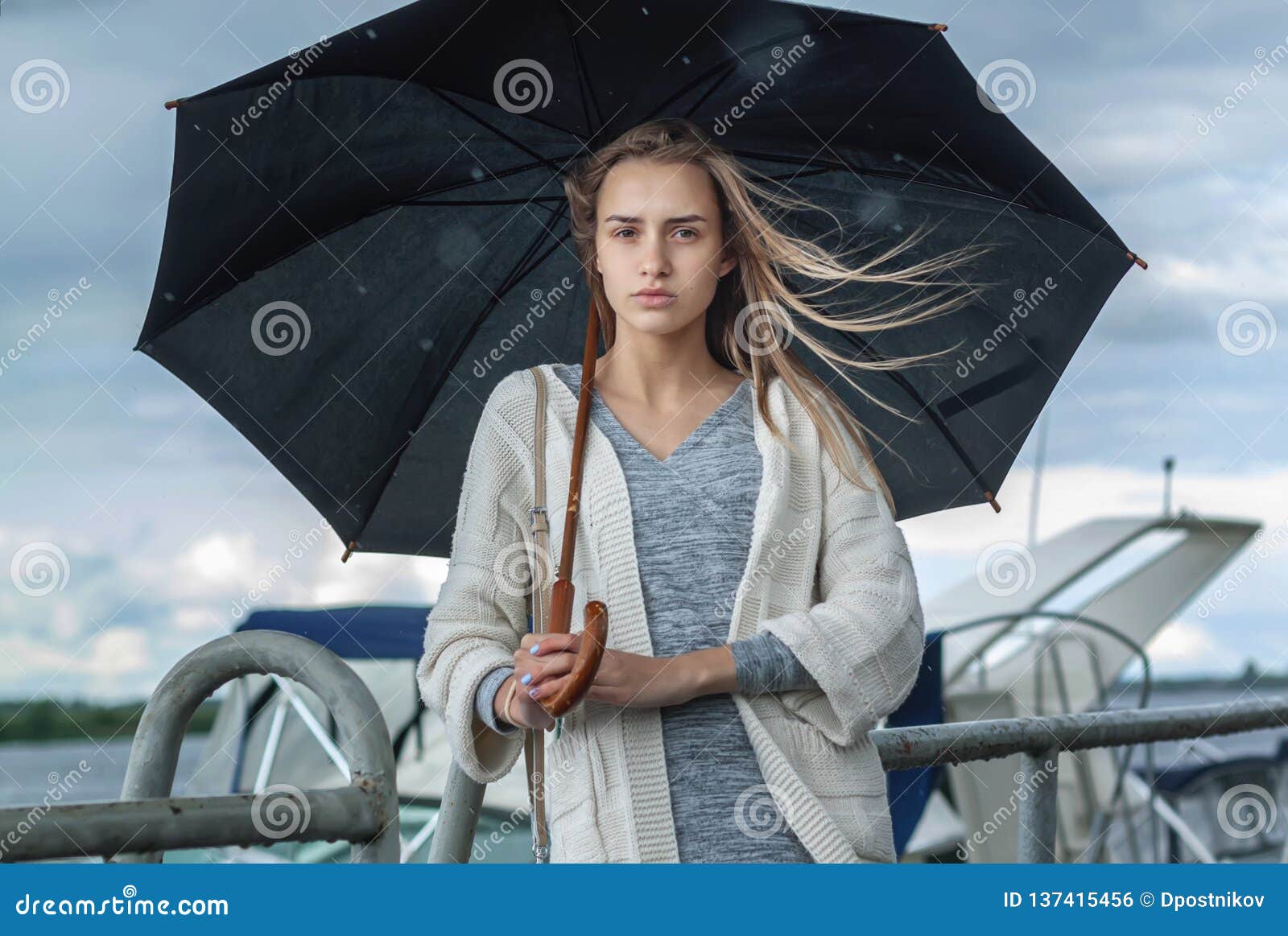 Sad Girl Hiding Under A Black Umbrella From The Rain