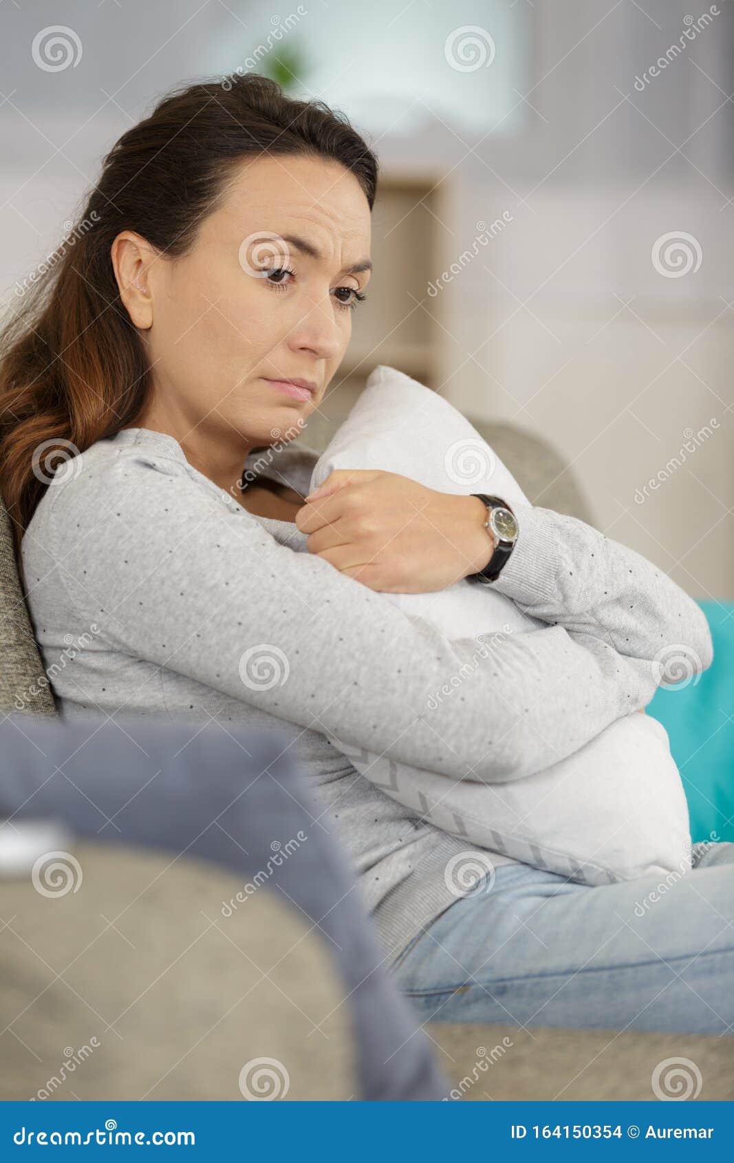 Sad girl hugging pillow stock photo. Image of confusion 164150354