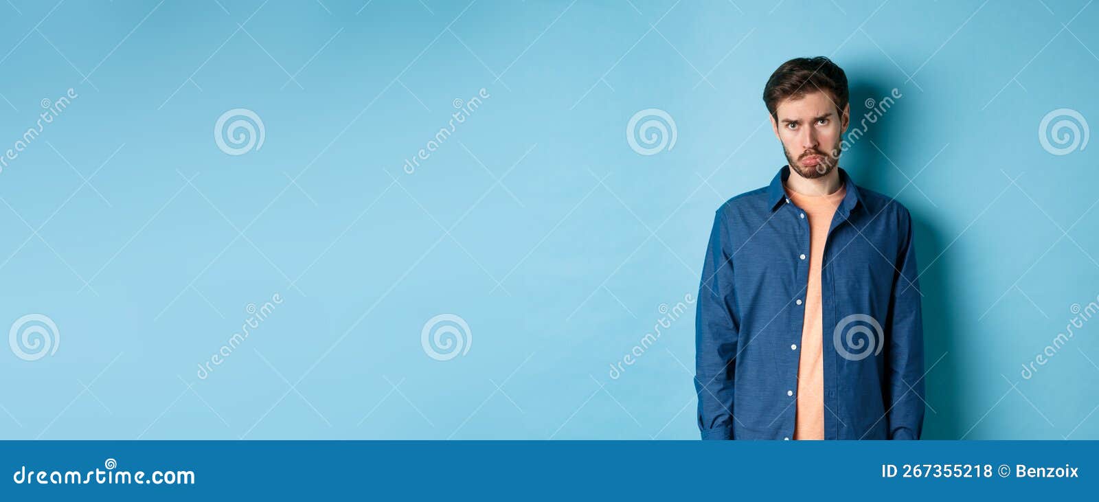 Sad and Gloomy Young Man Sulking, Pulling Miserable Face and Looking