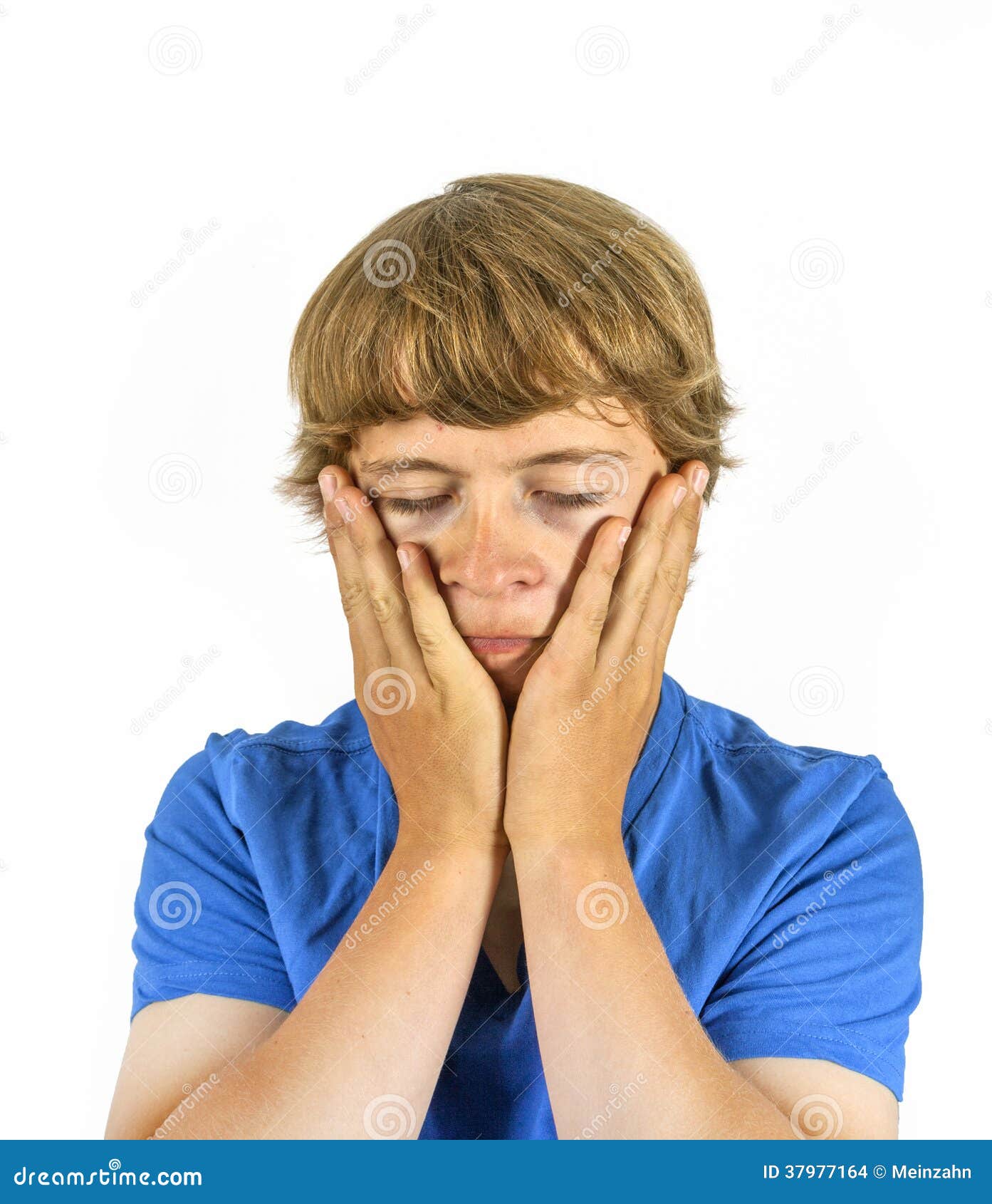 Sad teenage boy sitting in front German word for love on orange wall stock  photo