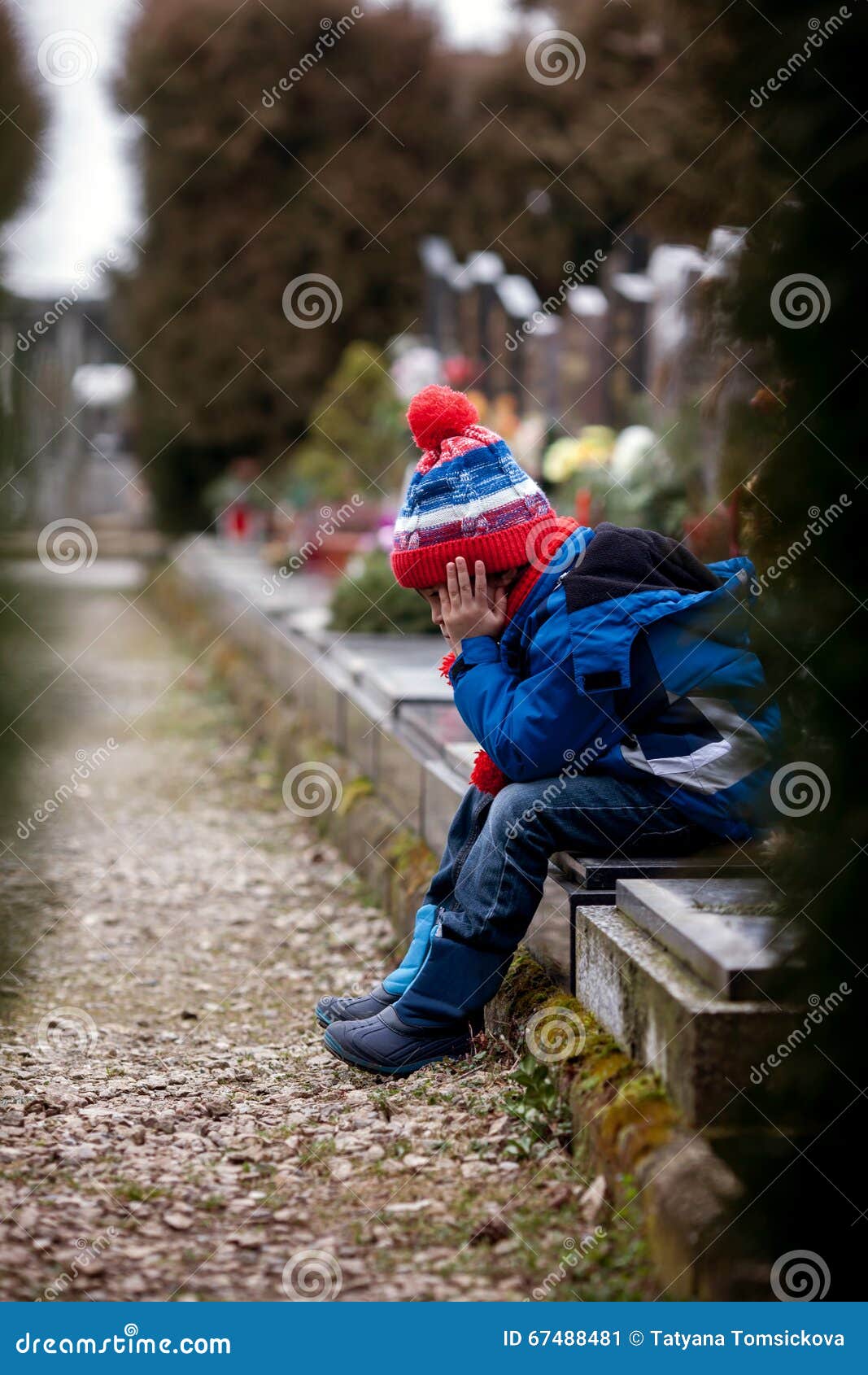 Sad Little Boy, Sitting on a Grave in a Cemetery Stock Image ...