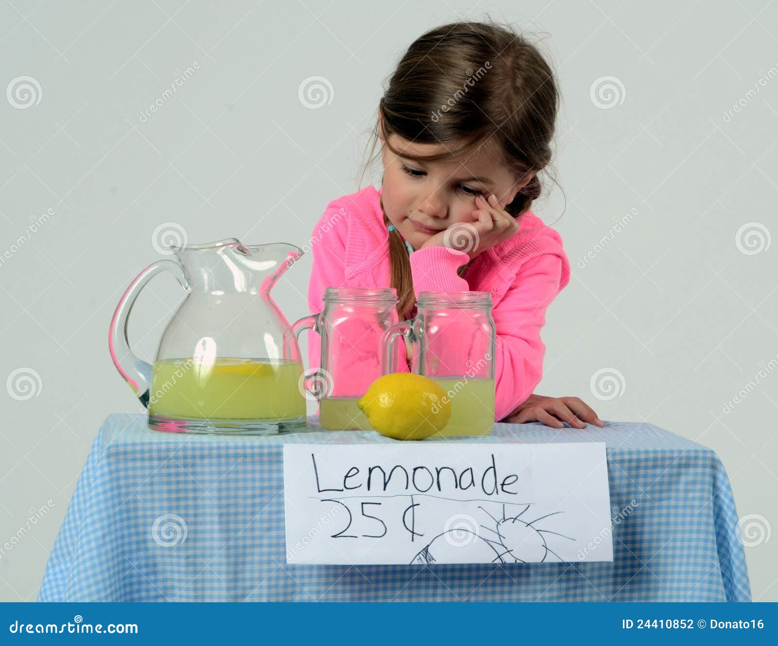 sad little girl at lemonade stand in summer