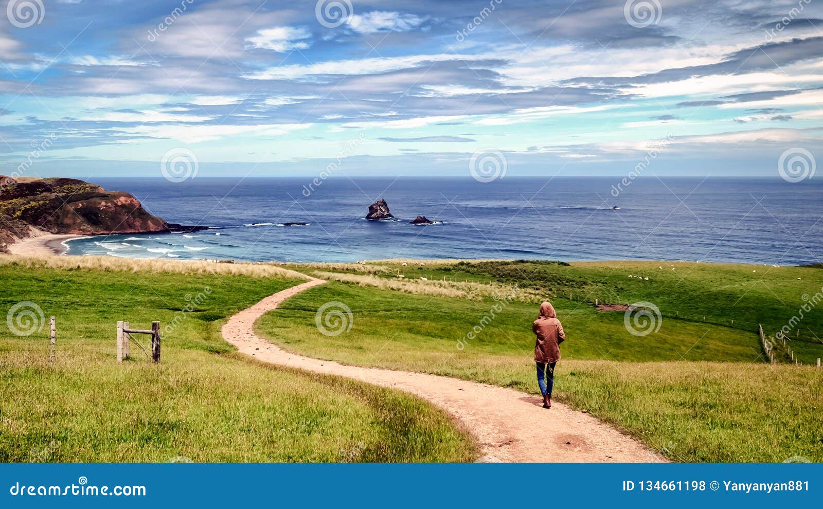 sad lonely girl follows a narrow path towards the beach