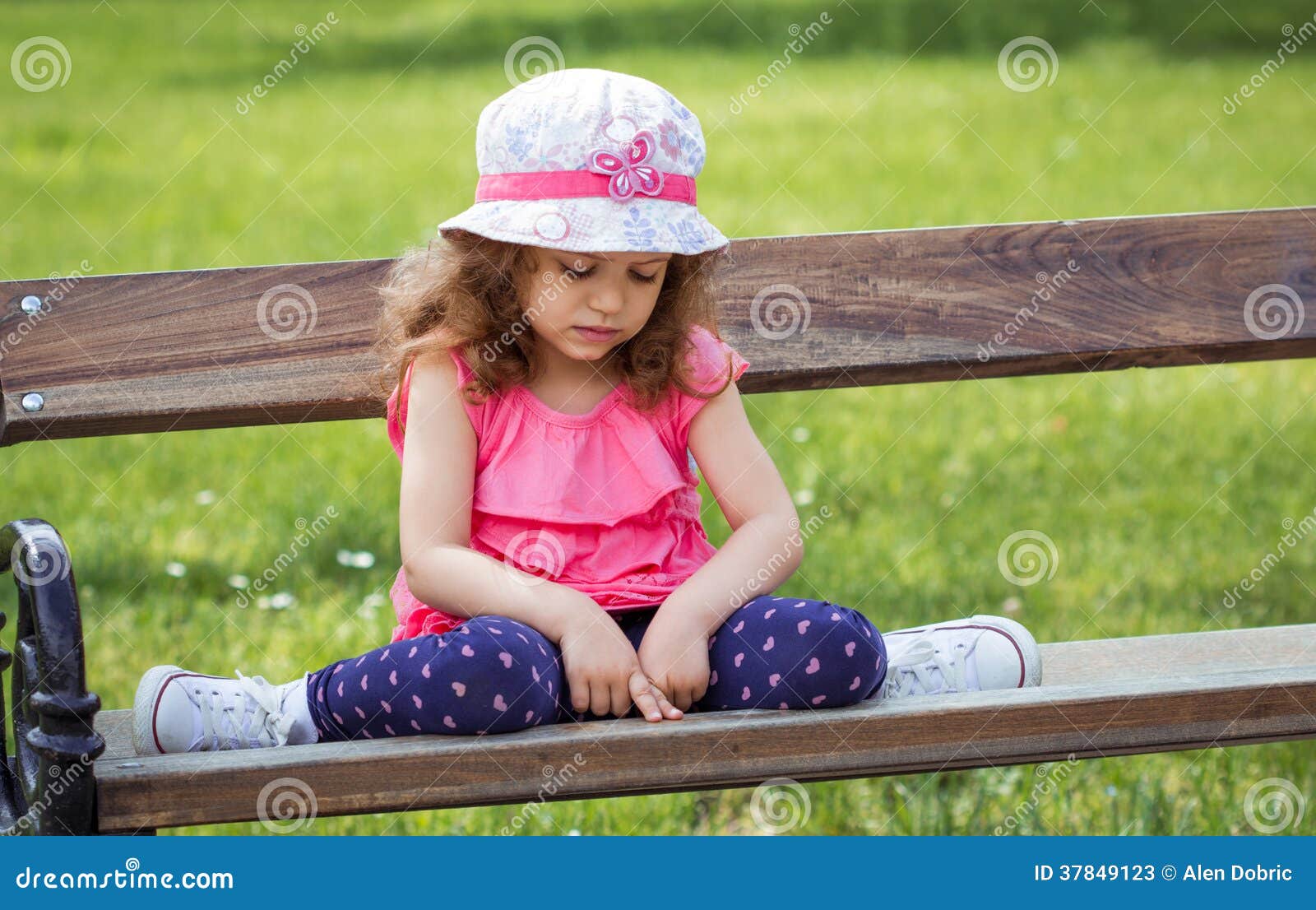 sad little girl sitting alone