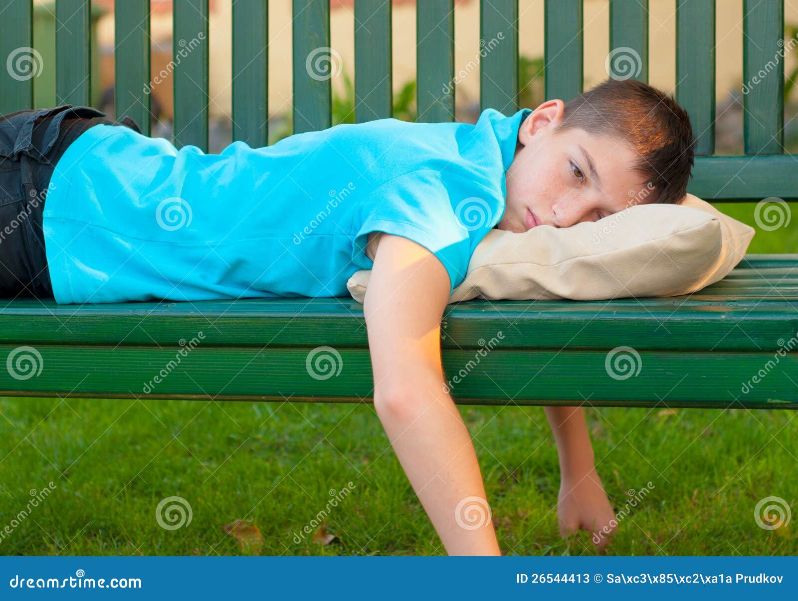 Sad Lonely Teenage Boy Lying On The Bench Stock Photos Image 26544413