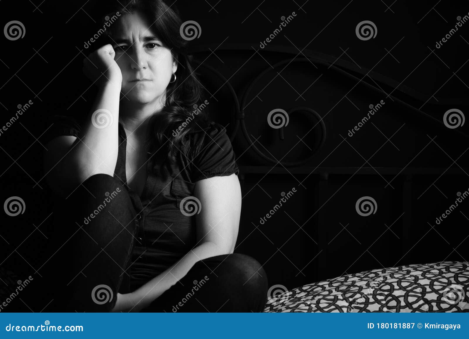 Sad and Lonely Woman Sitting on Her Bed - Black and White Portrait ...