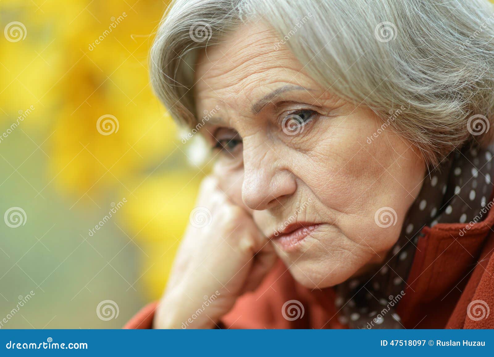 Sad old woman in park stock