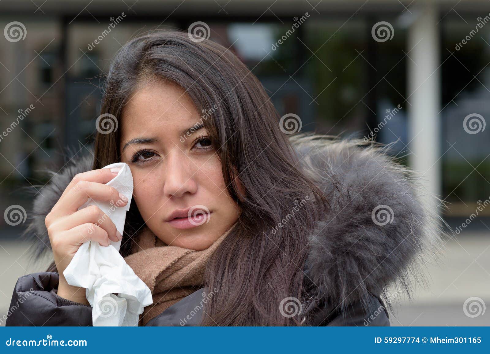 Download A Woman Holding A Sad Face On Her Face
