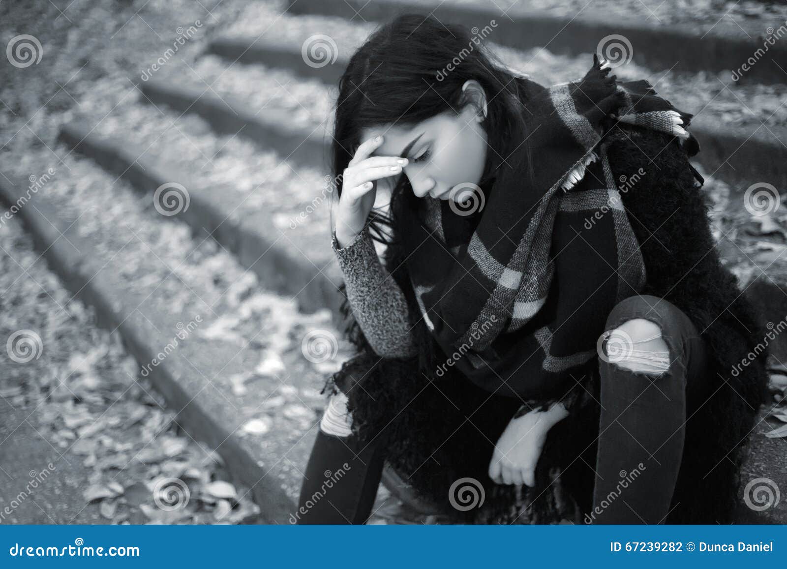 Sad girl sitting near window Stock Photo - Alamy