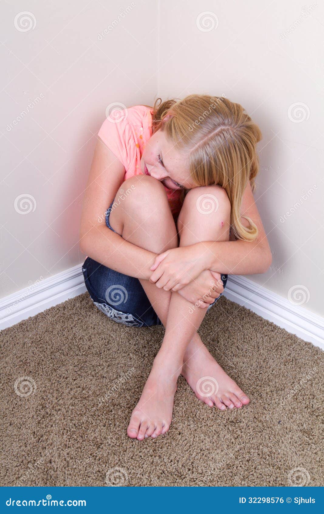 Sad Teen Sitting In Corner Stock Photo I