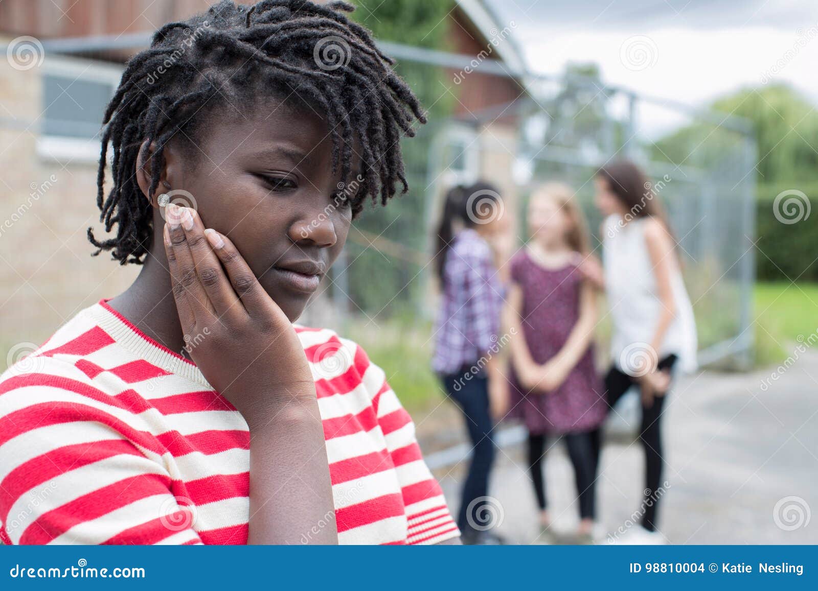 sad teenage girl feeling left out by friends