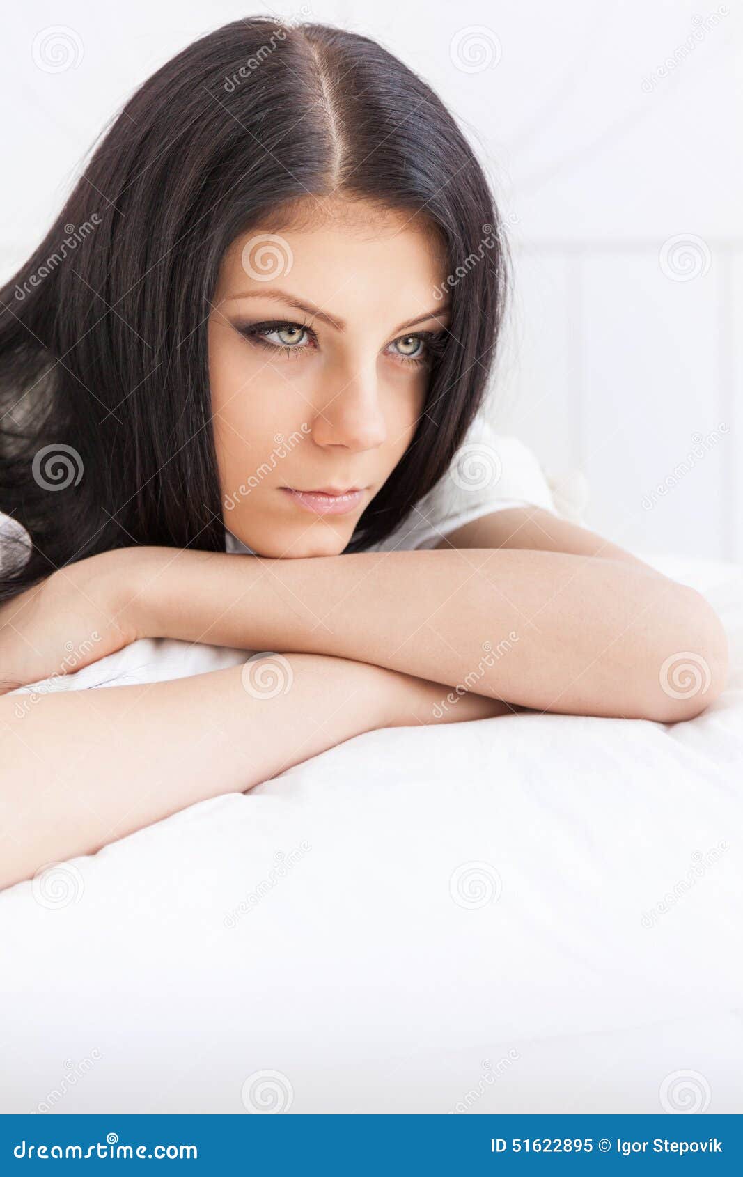 sad teenage girl thoughtfully reflects lying on the bed