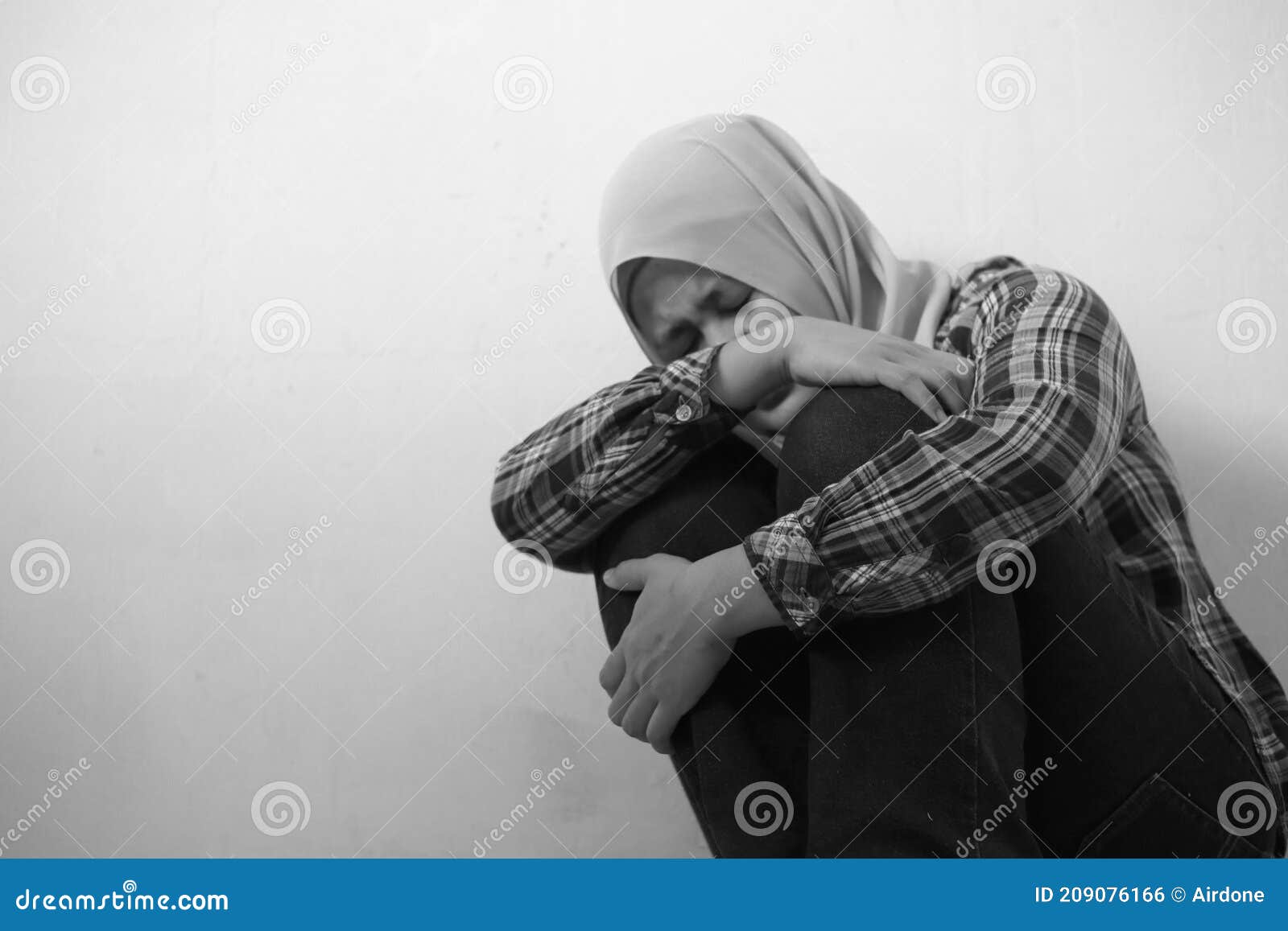 Sad Unhappy Lonely And Depressed Young Asian Muslim Woman Crouching And Crying At Home Stress 