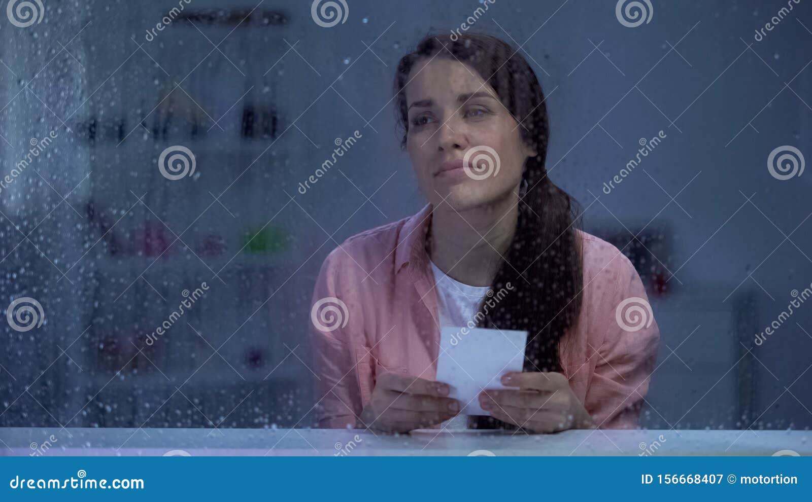 Sad Woman with Photo Feeling Sad Behind Rainy Window, Remembering ...