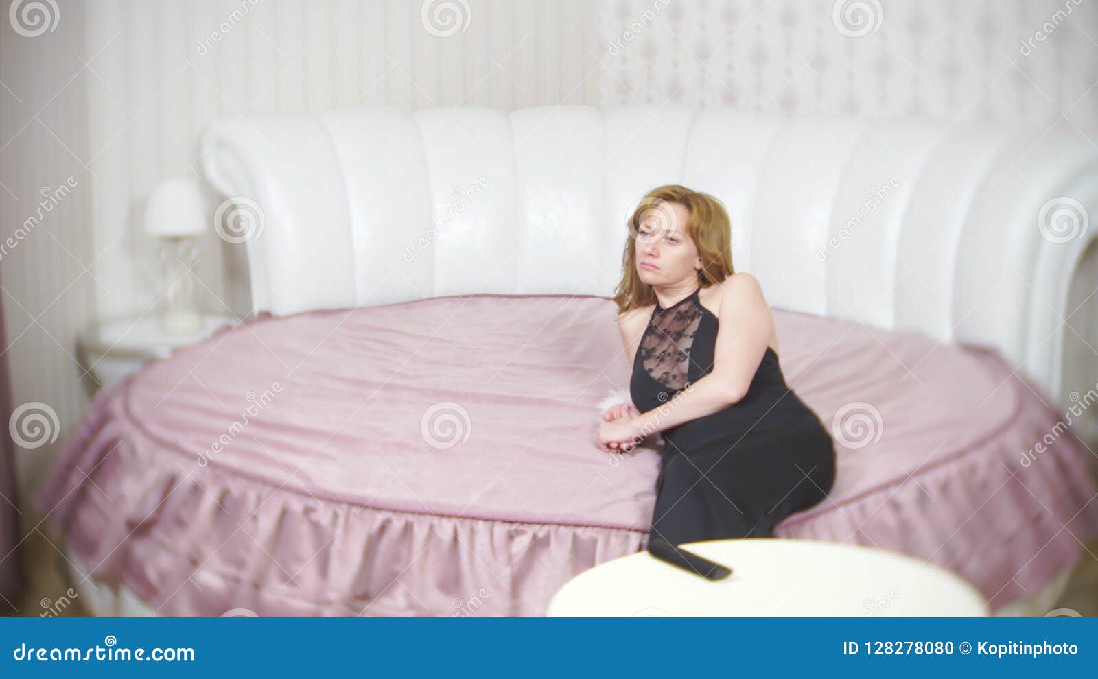 A Sad Woman Sitting On The Bed Feels Sad And Bored