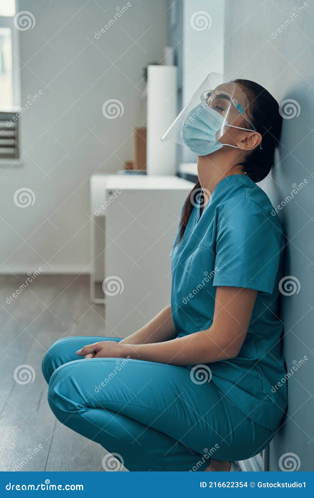 sad young female nurse in protective workwear
