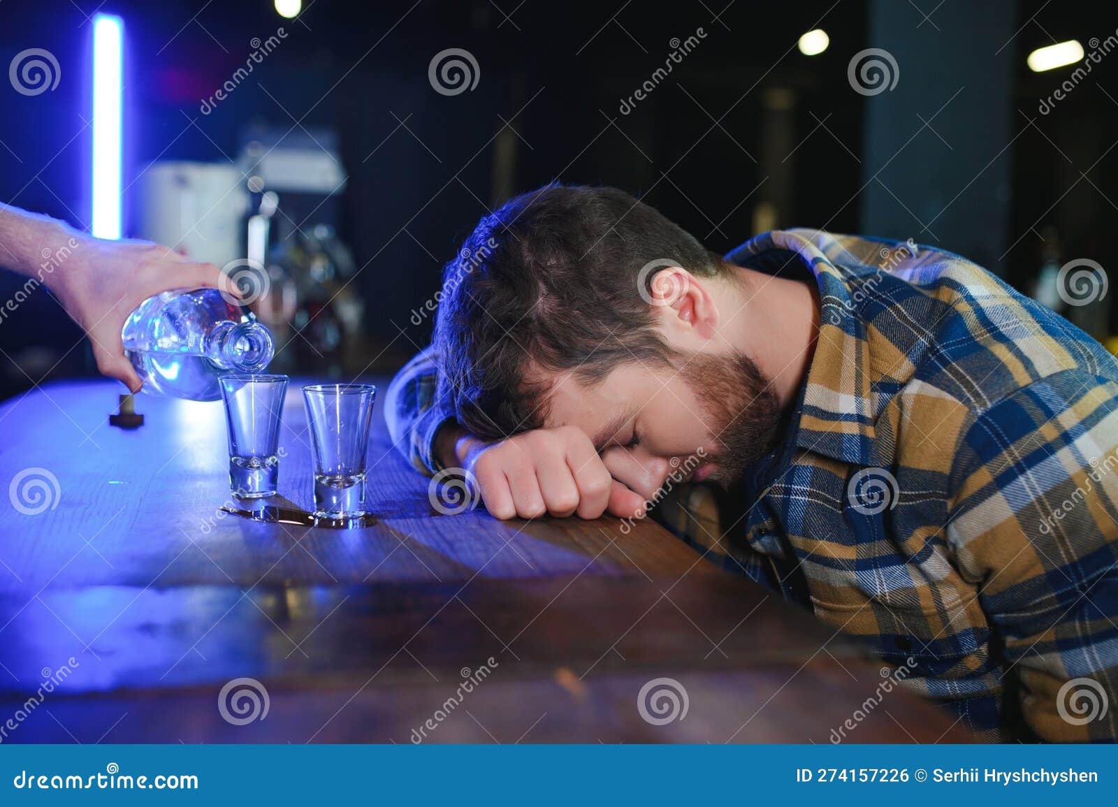 Sad Young Man Sitting at Bar Counter in Pub. Upset Man Drinks Alcohol ...