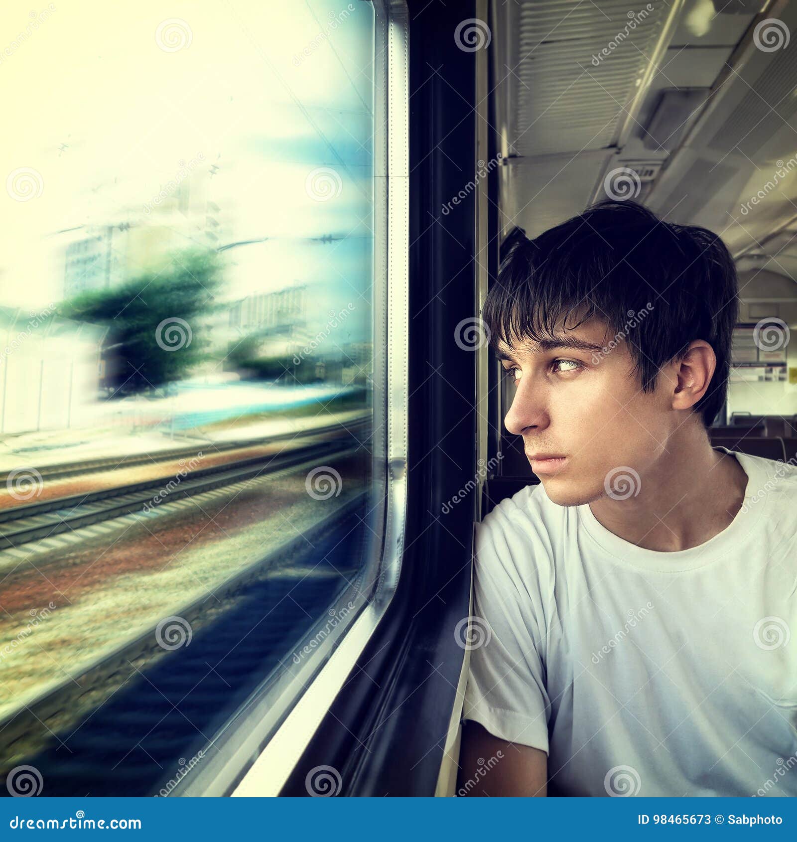 Young Man Looking Out Of Train Window Stock Photo - Download Image