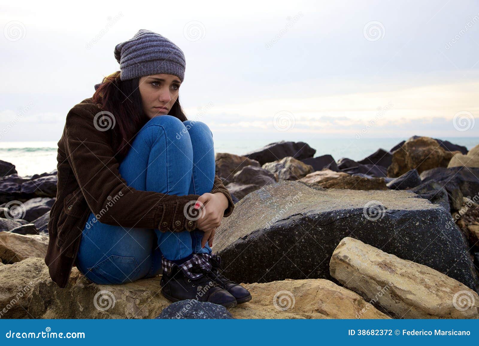 Sad Young Woman Sitting in Front of the Ocean Stock Photo - Image ...