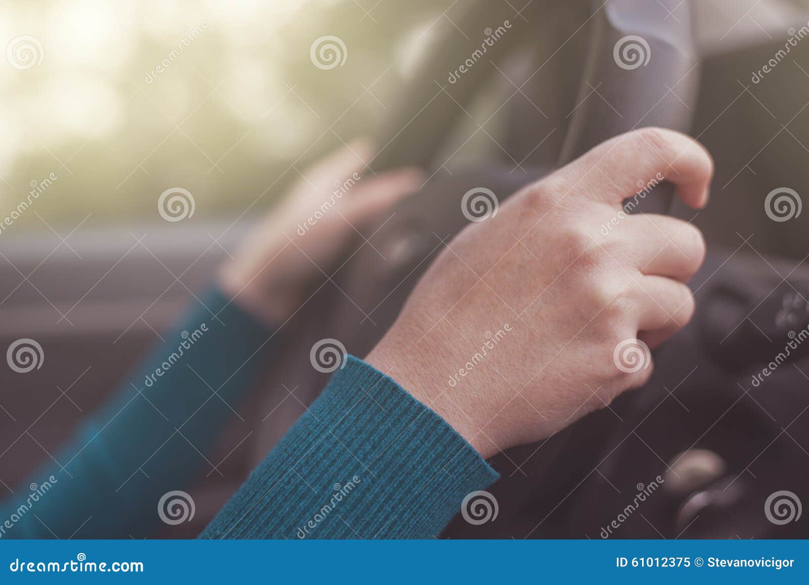 safe driving, woman grips car steering wheel