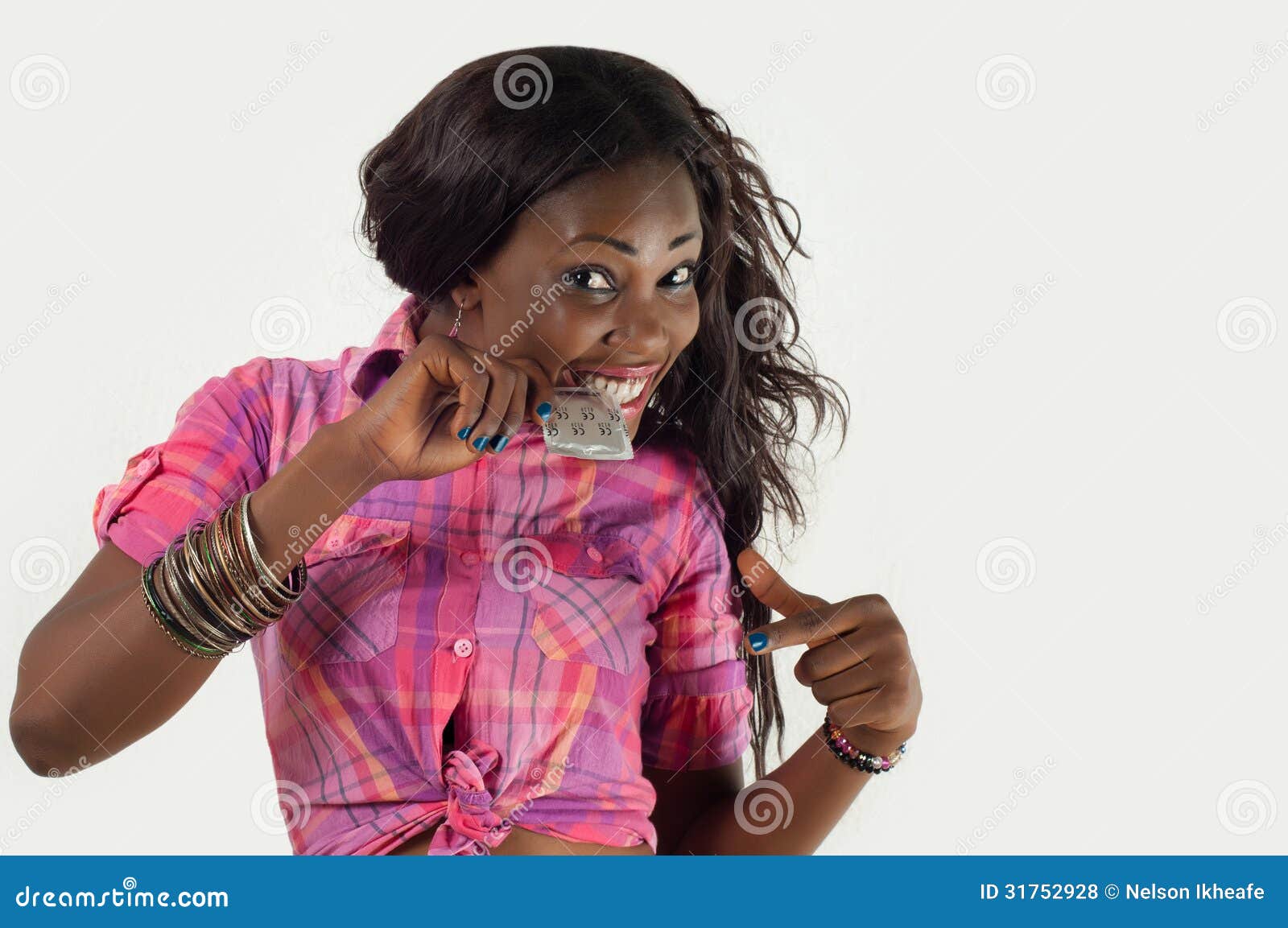 African American Girl Biting Condom-Safe Sex Stock Photo photo