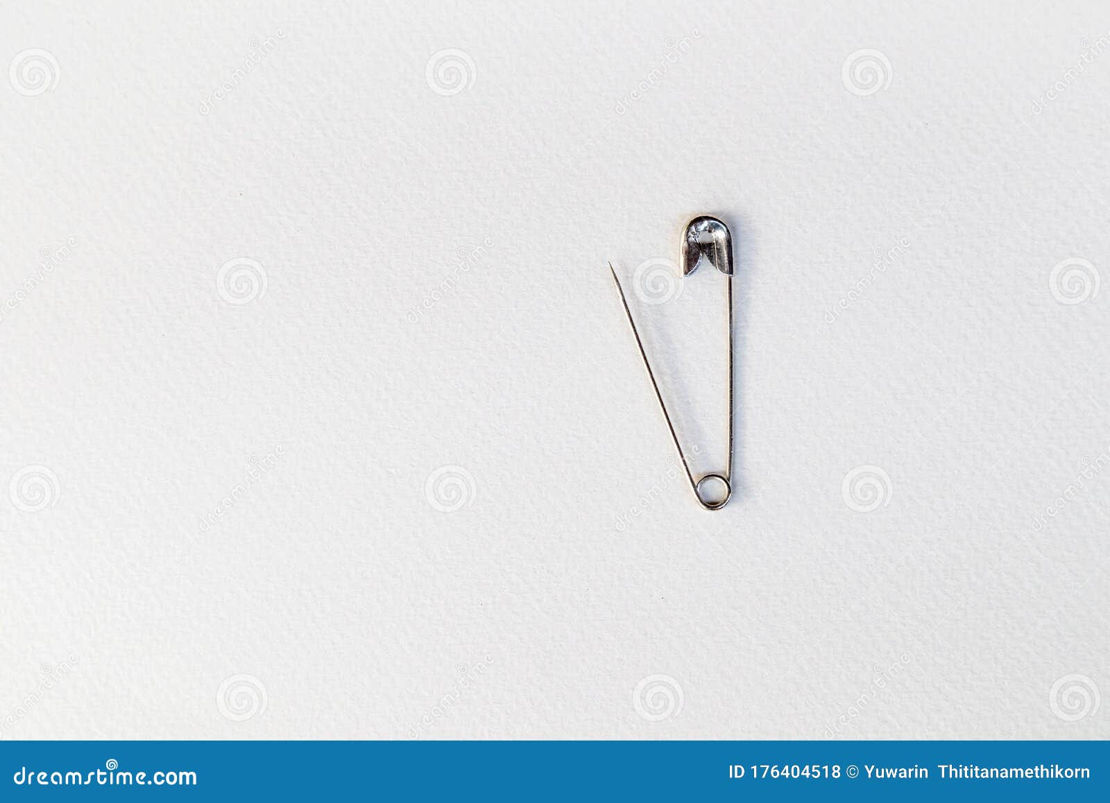 Safety Pin Made of Stainless Steel on a White Background. Stock Photo