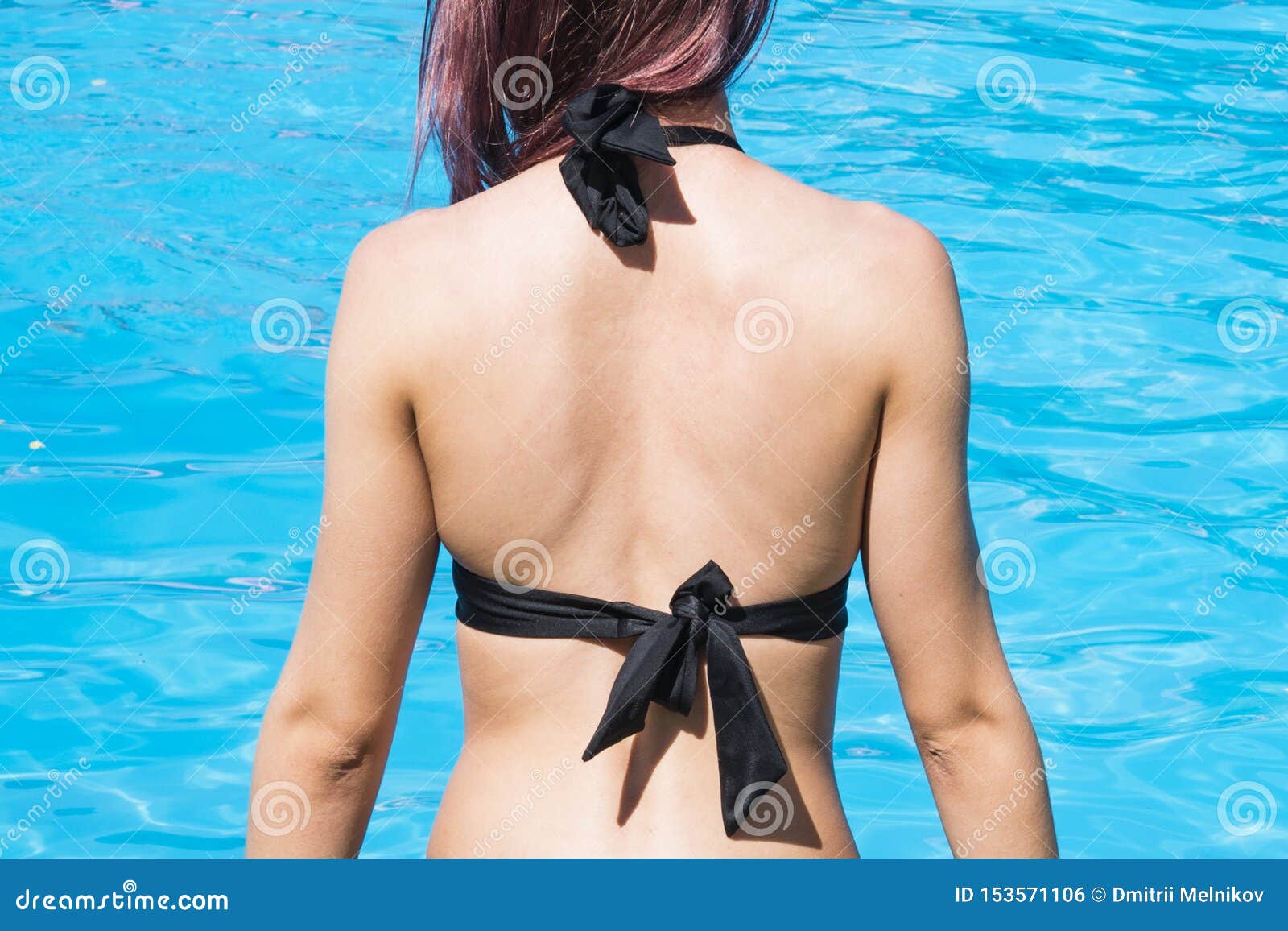 Dazzling babe sunbathing naked on a nudist beach
