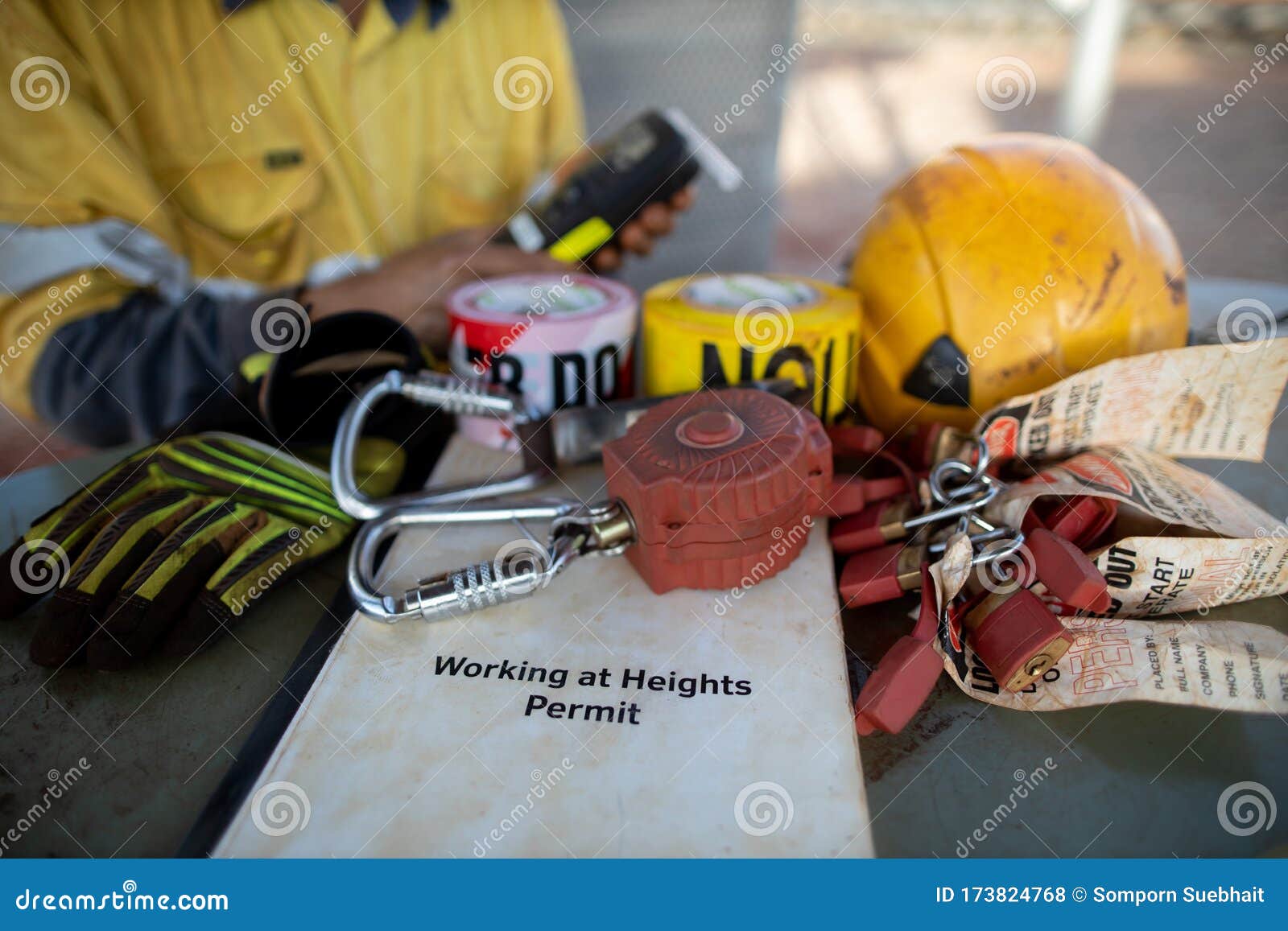 safety workplace working at heights permit book on the table defocused an inertia reel shock absorbing fall protection device