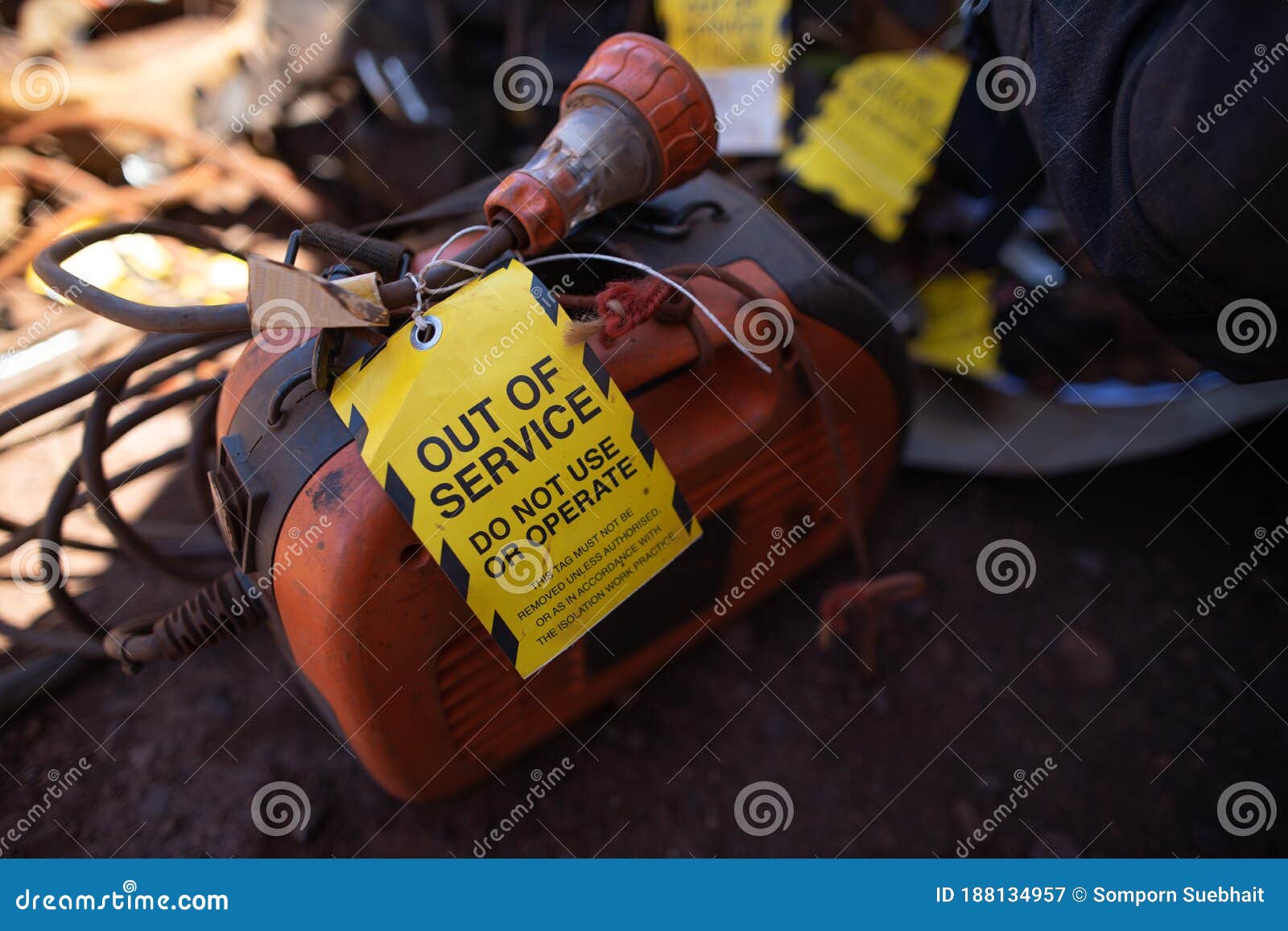 yellow out of service tag attached on faulty damage defect of welding machine at construction site perth, australia