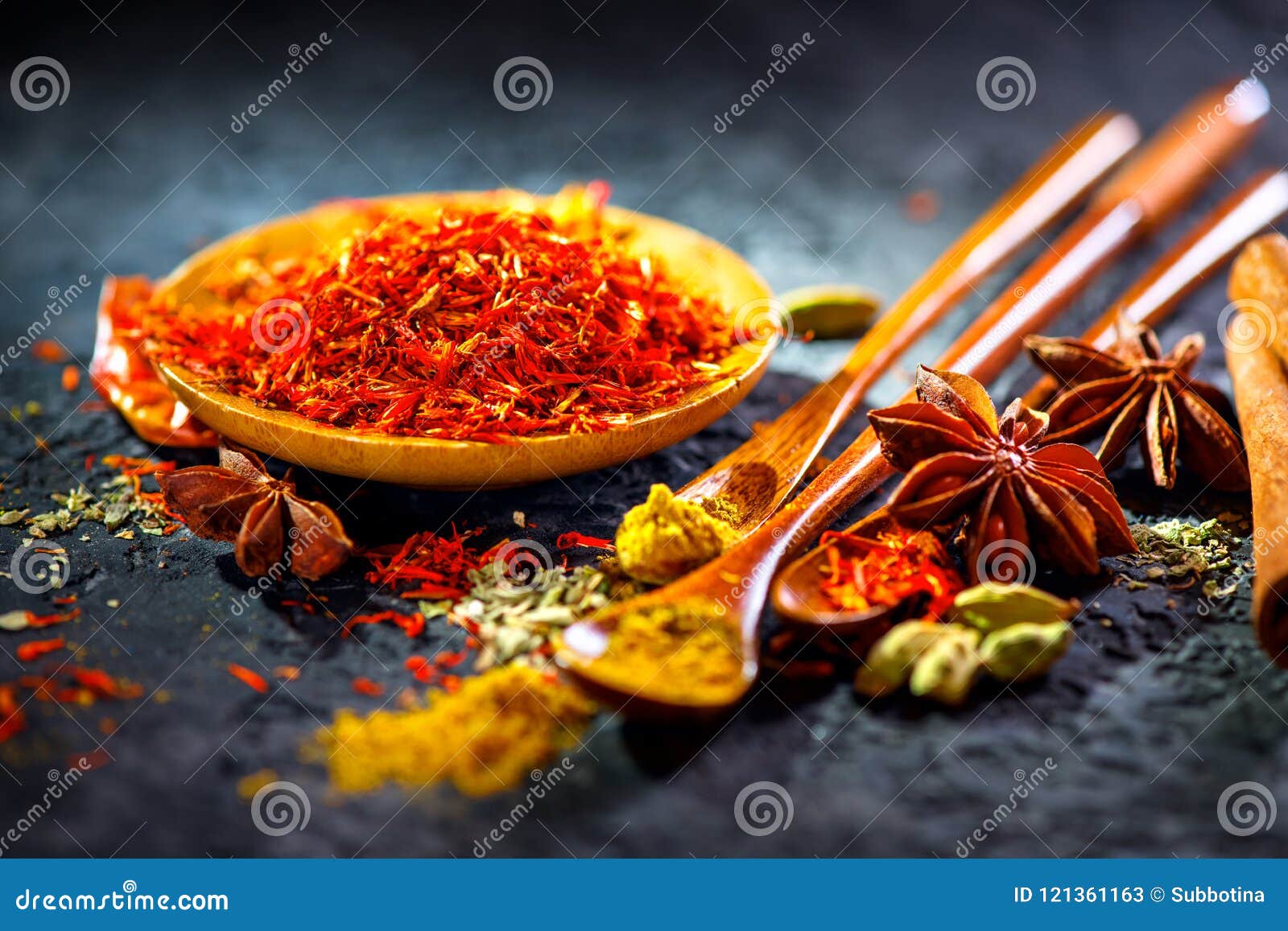 saffron. various indian spices on black stone table. spice and herbs on slate background