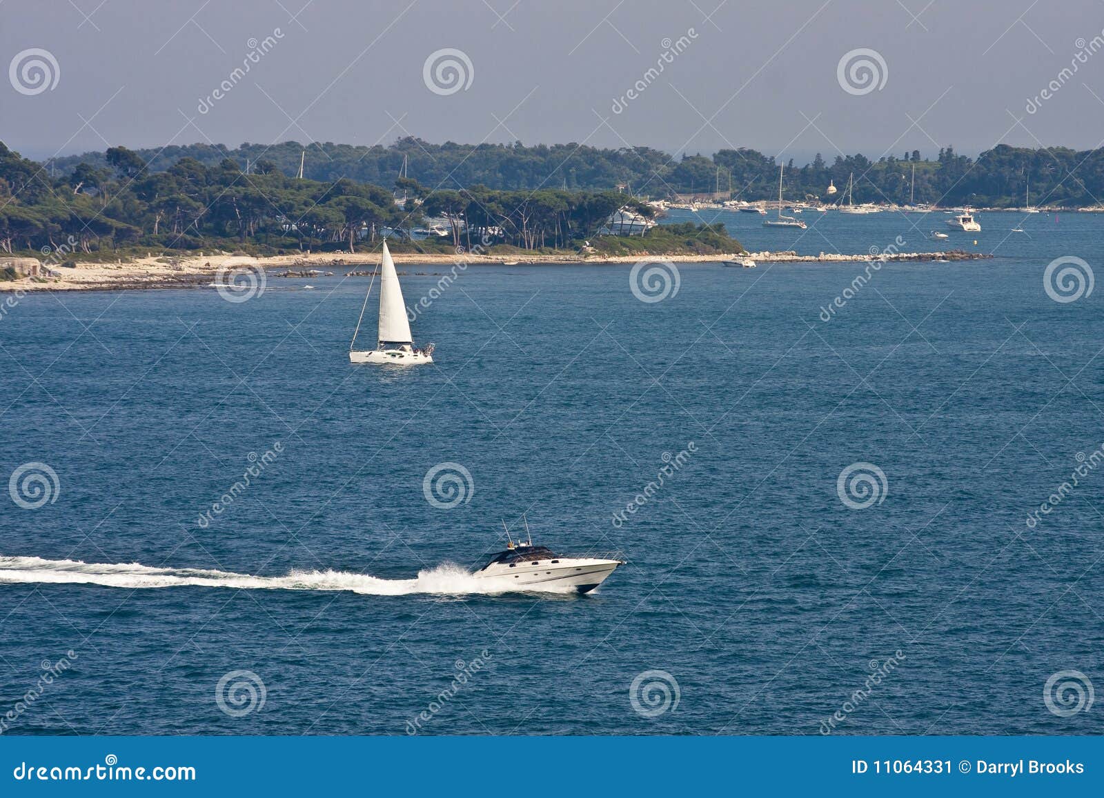 Sailboat And Cabin Cruiser In Bay Stock Image Image Of Blue