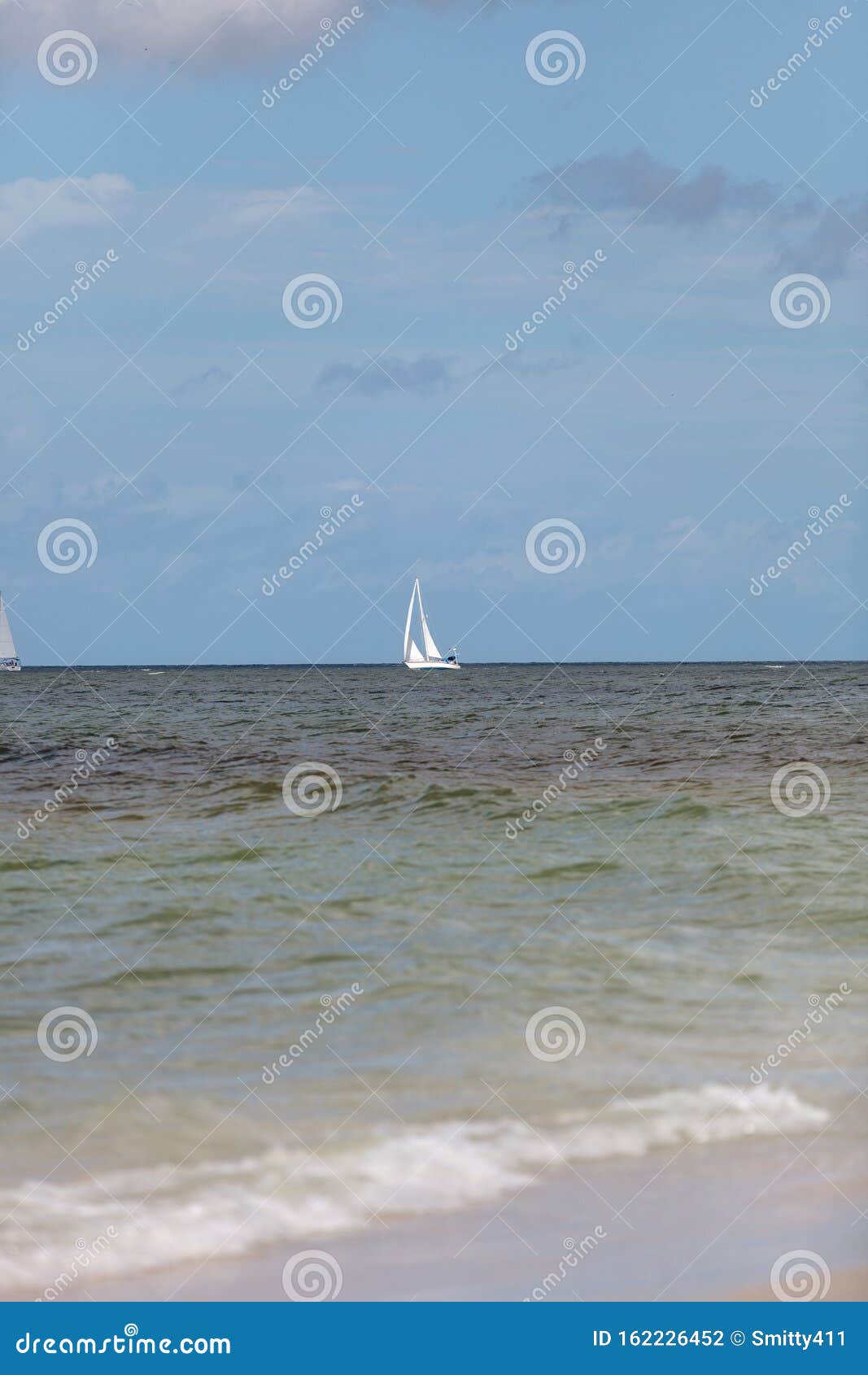 Sailboat Glides through the Ocean Off Naples Beach Stock Photo Image