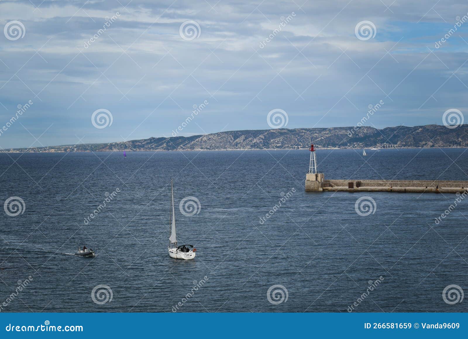 motorboat approaching sailboat head on