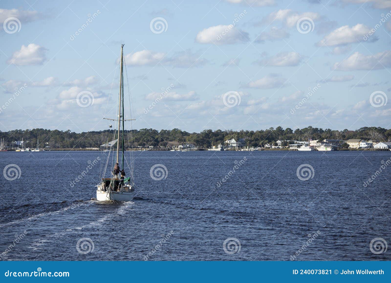 a sailboat moves across the water toward st marys, georgia in this view from the water